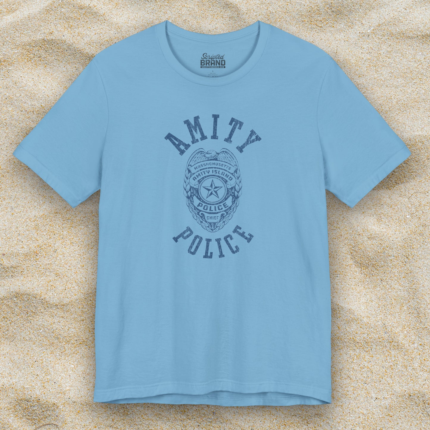 Front view of an ocean blue colored Soft unisex Bella+Canvas 3001 short-sleeve t-shirt featuring an Amity Island Police logo graphic, designed by ScriptedBrand, and inspired by the movie Jaws in a vintage distressed style.