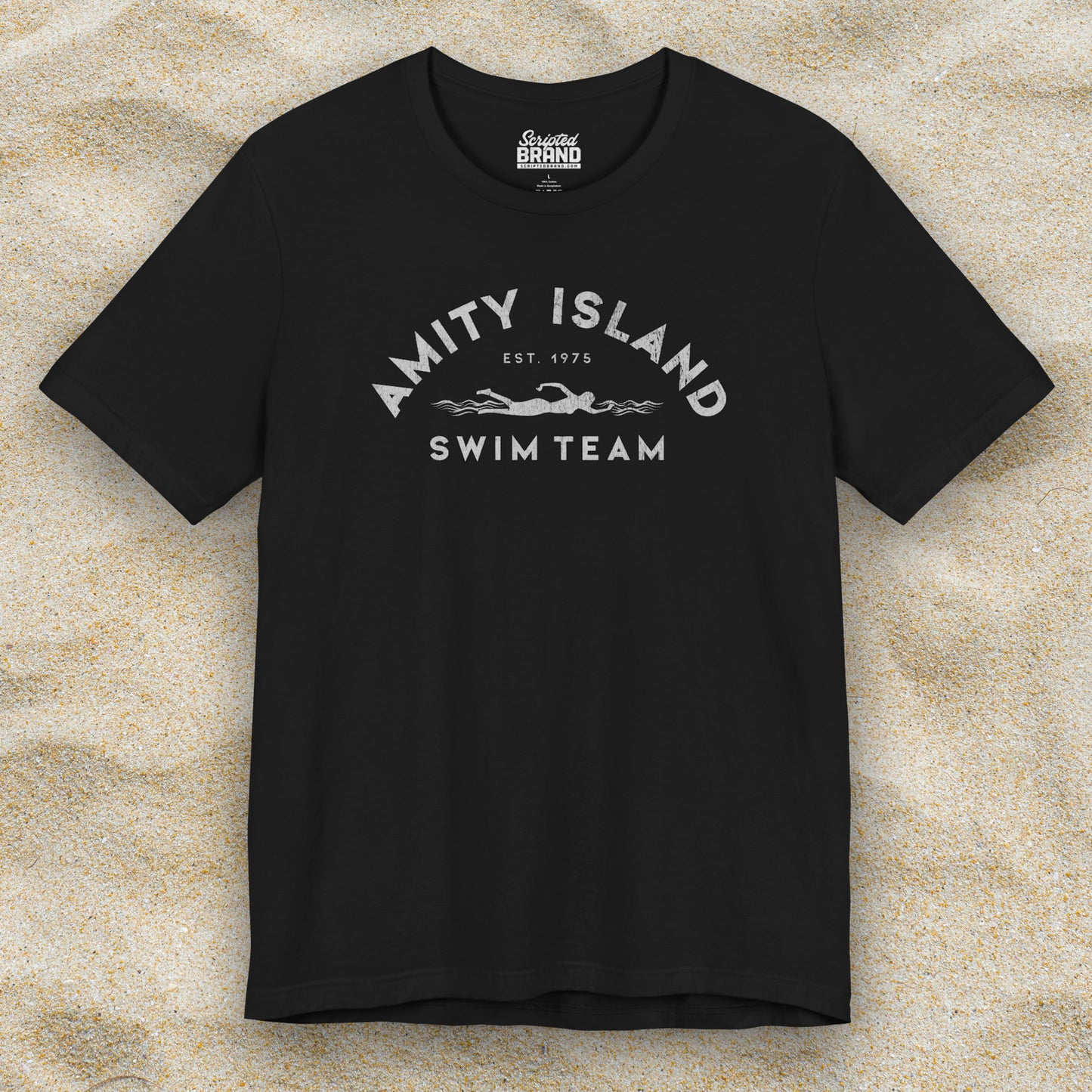 Front view of a black colored Soft unisex Bella+Canvas 3001 short-sleeve t-shirt featuring an Amity Island Swim Team logo graphic, designed by ScriptedBrand, and inspired by the movie Jaws in a vintage distressed style.