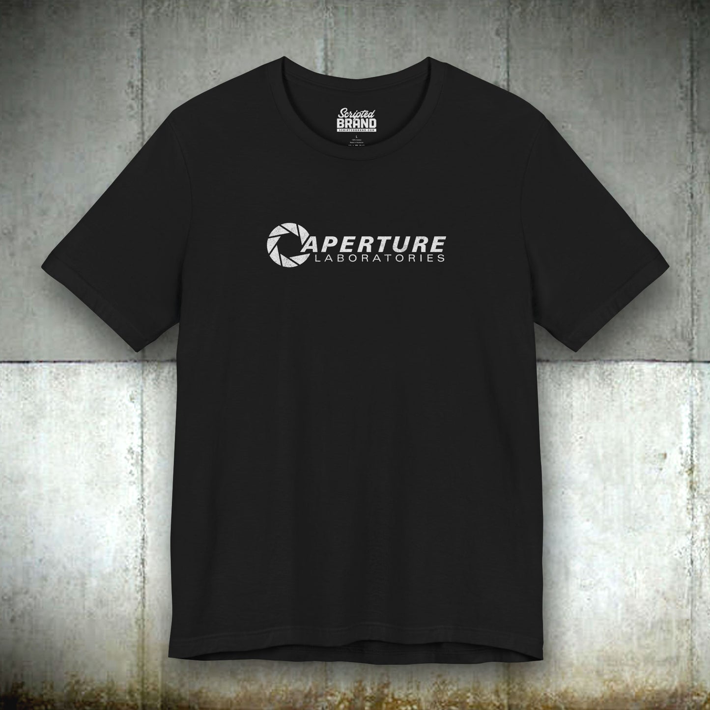 Black colored soft Bella+Canvas t-shirt with the Aperture Laboratories logo from the video game Portal and Portal 2 in a vintage ink-stamped distressed style.
