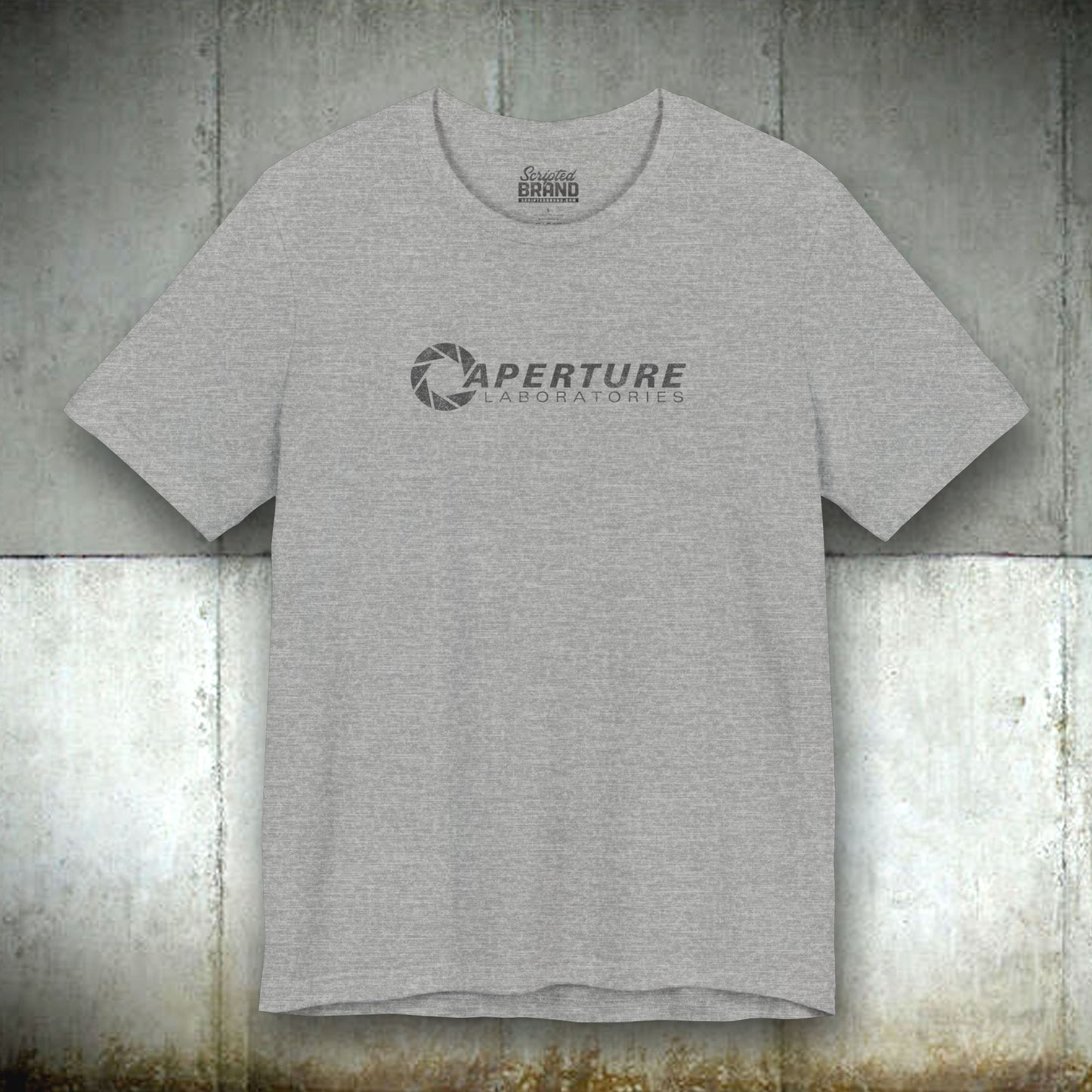 Athletic grey colored soft Bella+Canvas t-shirt with the Aperture Laboratories logo from the video game Portal and Portal 2 in a vintage ink-stamped distressed style.