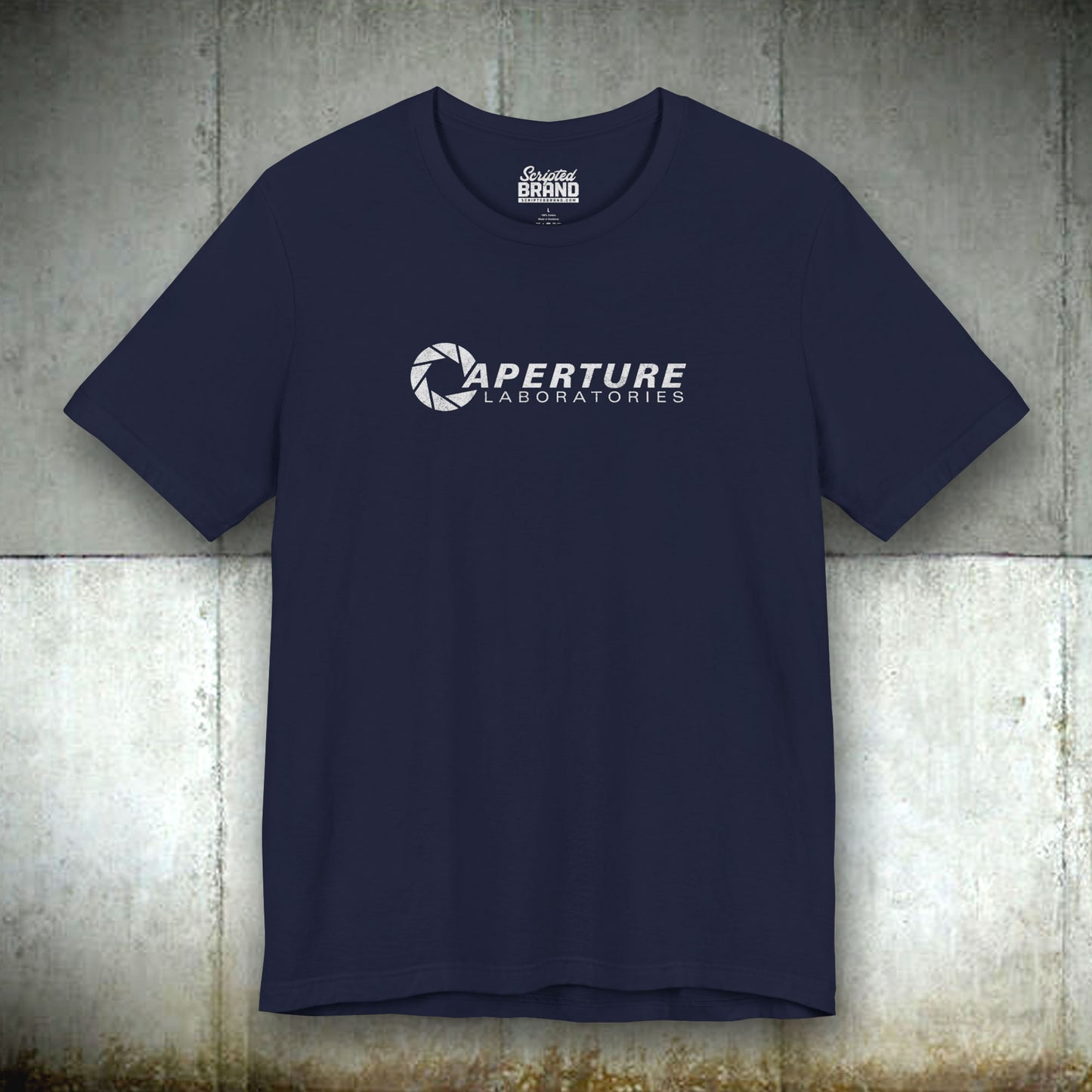 Navy blue colored soft Bella+Canvas t-shirt with the Aperture Laboratories logo from the video game Portal and Portal 2 in a vintage ink-stamped distressed style.