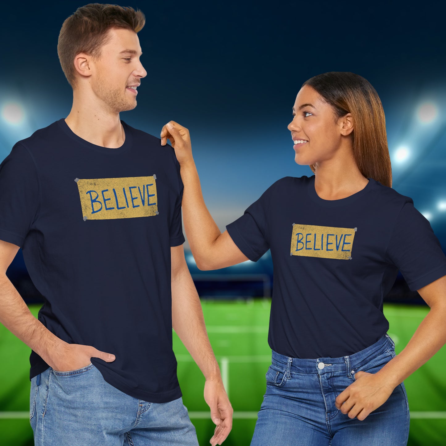 2 models wearing navy blue soft Bella+Canvas 3001 short-sleeve t-shirts featuring a logo graphic of the BELIEVE sign Ted Lasso hung in the fictional English soccer team AFC Richmond locker room, inspired by the TV show Ted Lasso in a vintage distressed style, sold by ScriptedBrand.