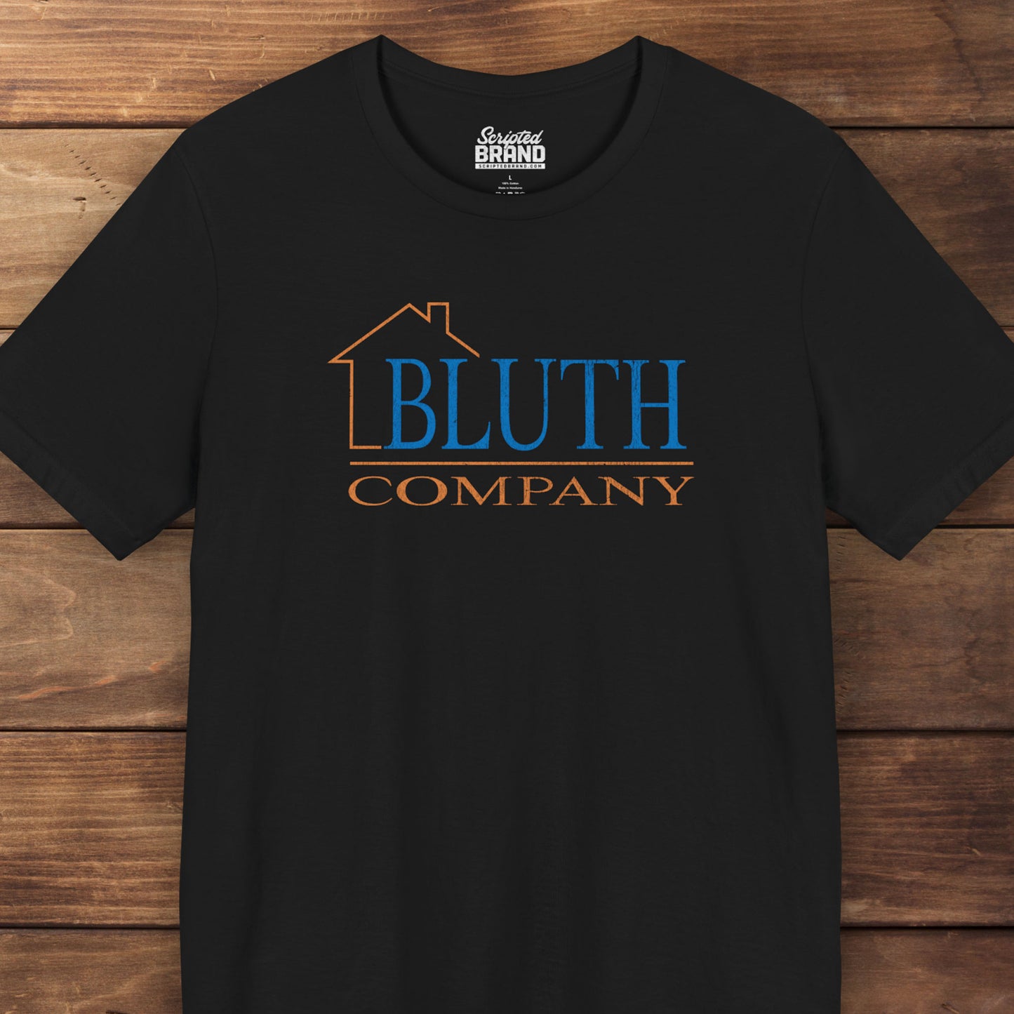 Front view of black Bella+Canvas t-shirt featuring a vintage Bluth Company logo inspired by the TV show Arrested Development.