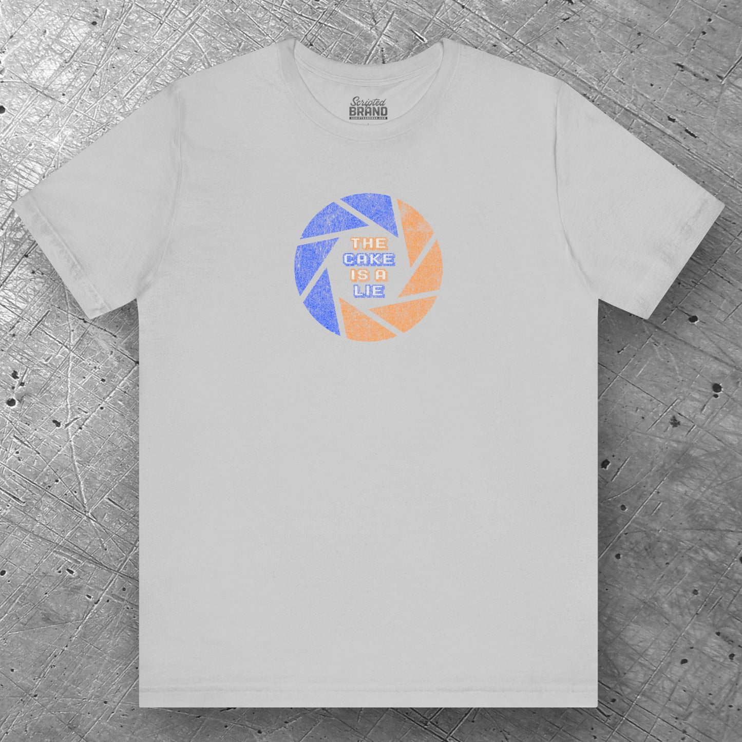 Front view of a solid athletic grey colored soft Bella+Canvas 3001 short-sleeve t-shirt featuring the phrase The Cake Is a Lie, along with the Aperture Laboratories shutter logo from the video game Portal and Portal 2 in a vintage distressed style, sold by ScriptedBrand.