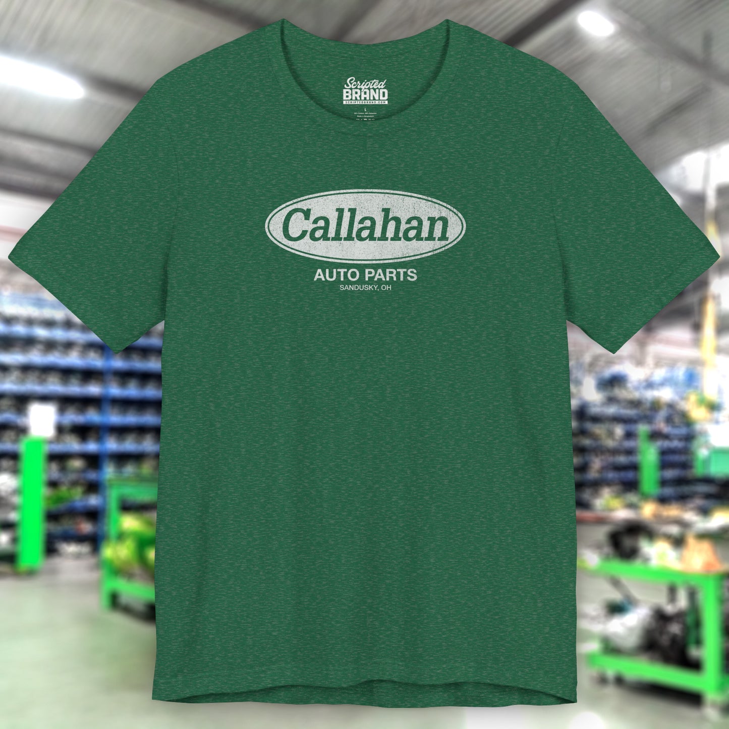 Front view of a Heather Grass Green colored soft short-sleeve t-shirt with the Callahan Auto Parts logo from the movie Tommy Boy in a vintage distressed style.