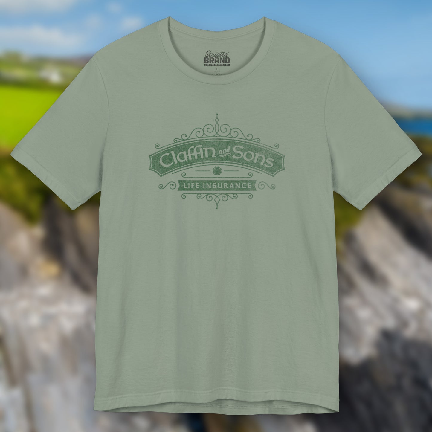 Front view of a sage colored soft Bella+Canvas 3001 short-sleeve t-shirt featuring a logo graphic of Claffin & Sons Insurance, designed by ScriptedBrand in a vintage distressed vintage distressed style, inspired by the TV show Bad Sisters.