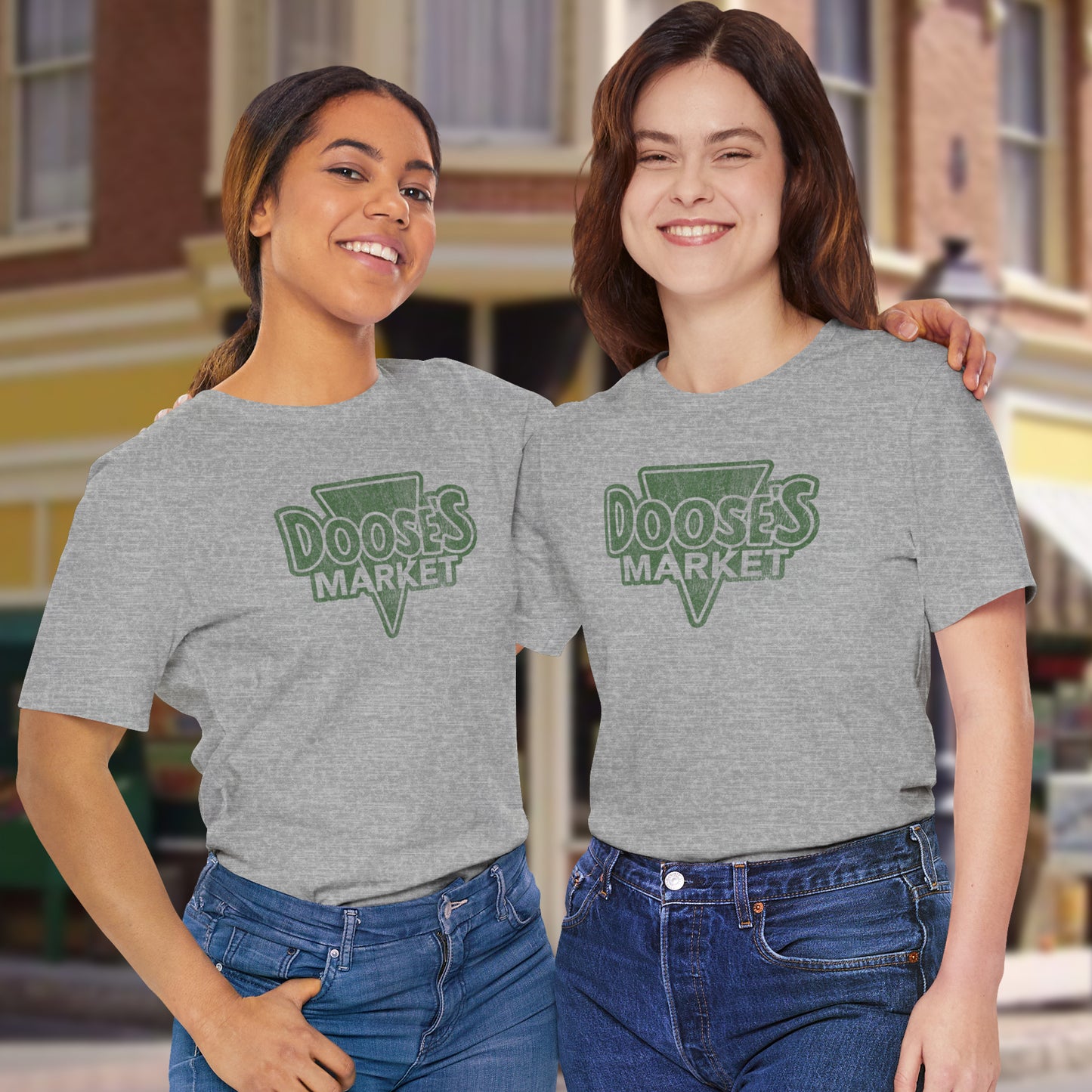 two women wearing gray Bella+Canvas t-shirts with a vintage-style Doose’s Market logo graphic, inspired by Gilmore Girls