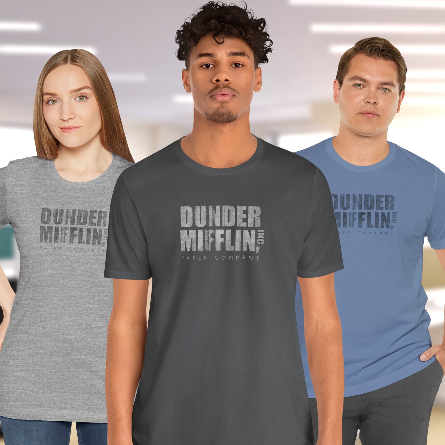 Three people wearing t-shirts featuring the Dunder Mifflin logo from the TV show The Office in a vintage distressed style.