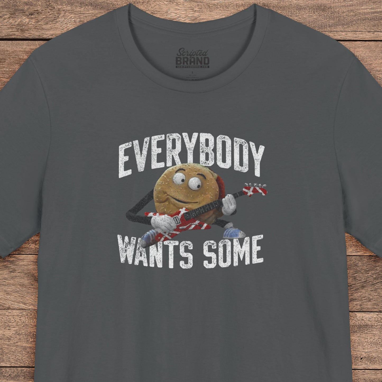 Asphalt Gray t-shirt with the phrase EVERYBODY WANTS SOME and a graphic of the guitar playing hamburger from the movie Better Off Dead in a vintage style.