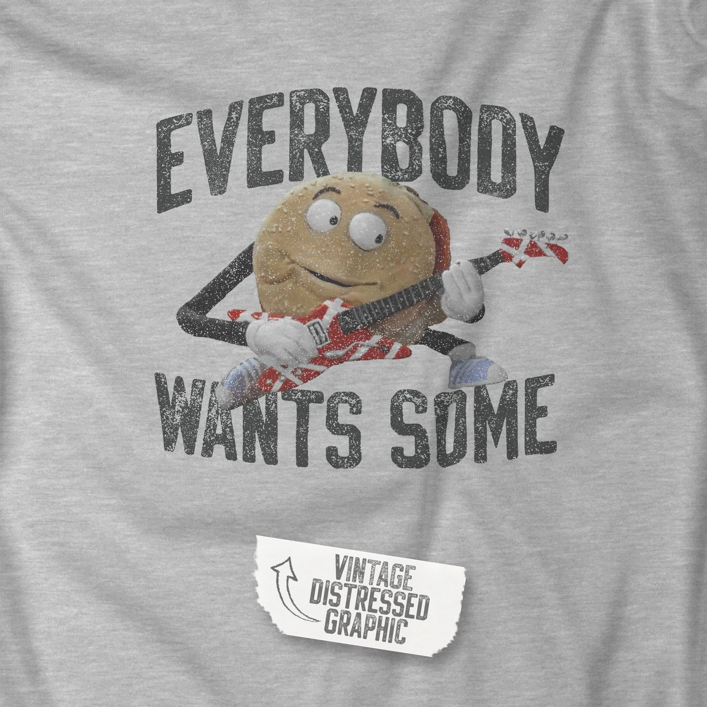 Closeup view of an athletic heather grey colored soft Bella+Canvas 3001 short-sleeve t-shirt featuring the phrase EVERYBODY WANTS SOME with a graphic of the Van Halen singing hamburger playing guitar from the movie Better Off Dead, designed by ScriptedBrand in a vintage distressed style.