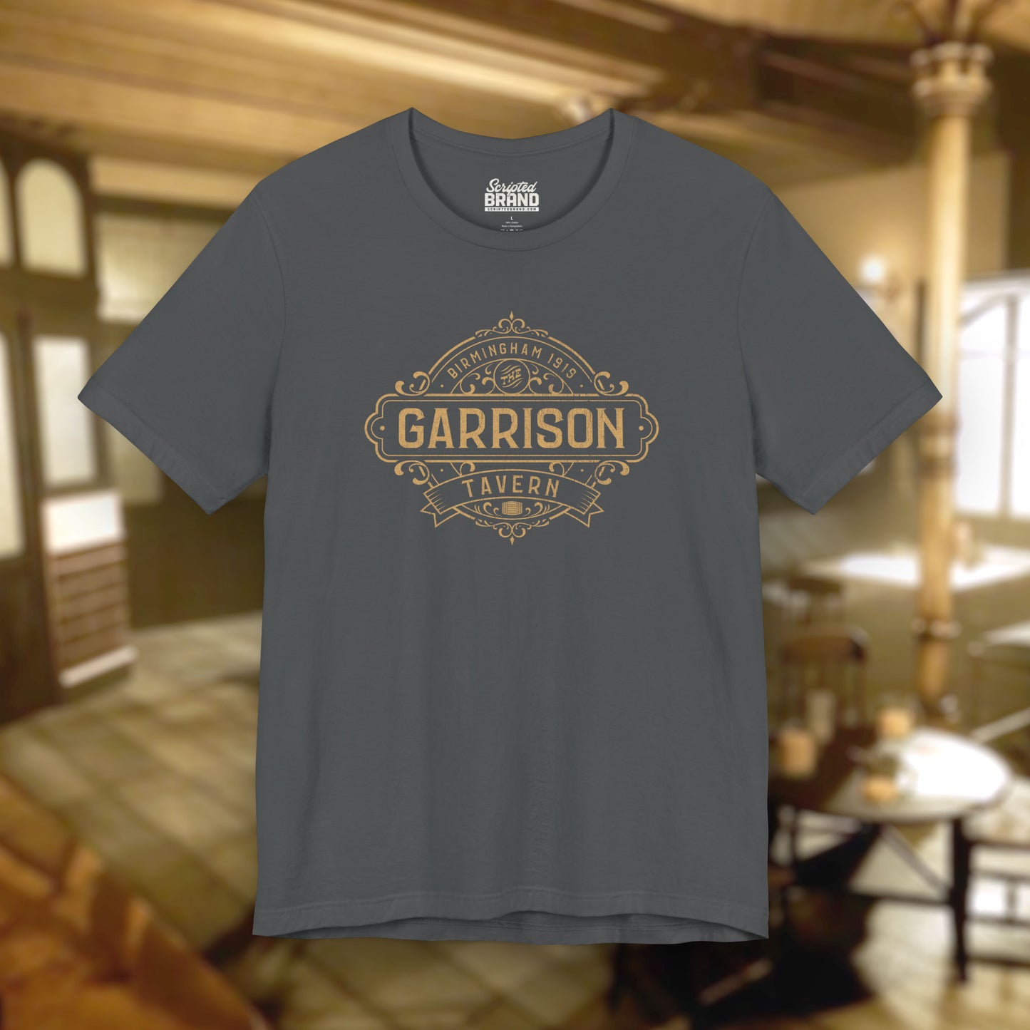 Front view of a asphalt gray soft Bella+Canvas 3001 short-sleeve t-shirt featuring the Garrison Tavern Bar Logo Graphic inspired by the TV show and movie Peaky Blinders in a vintage distressed style, sold by ScriptedBrand.