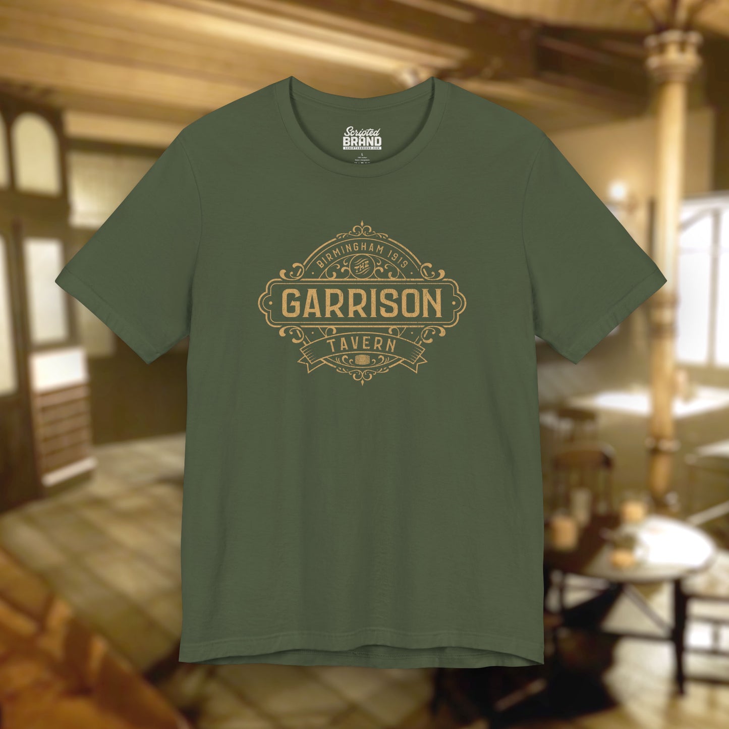 Front view of a military green soft Bella+Canvas 3001 short-sleeve t-shirt featuring the Garrison Tavern Bar Logo Graphic inspired by the TV show and movie Peaky Blinders in a vintage distressed style, sold by ScriptedBrand.