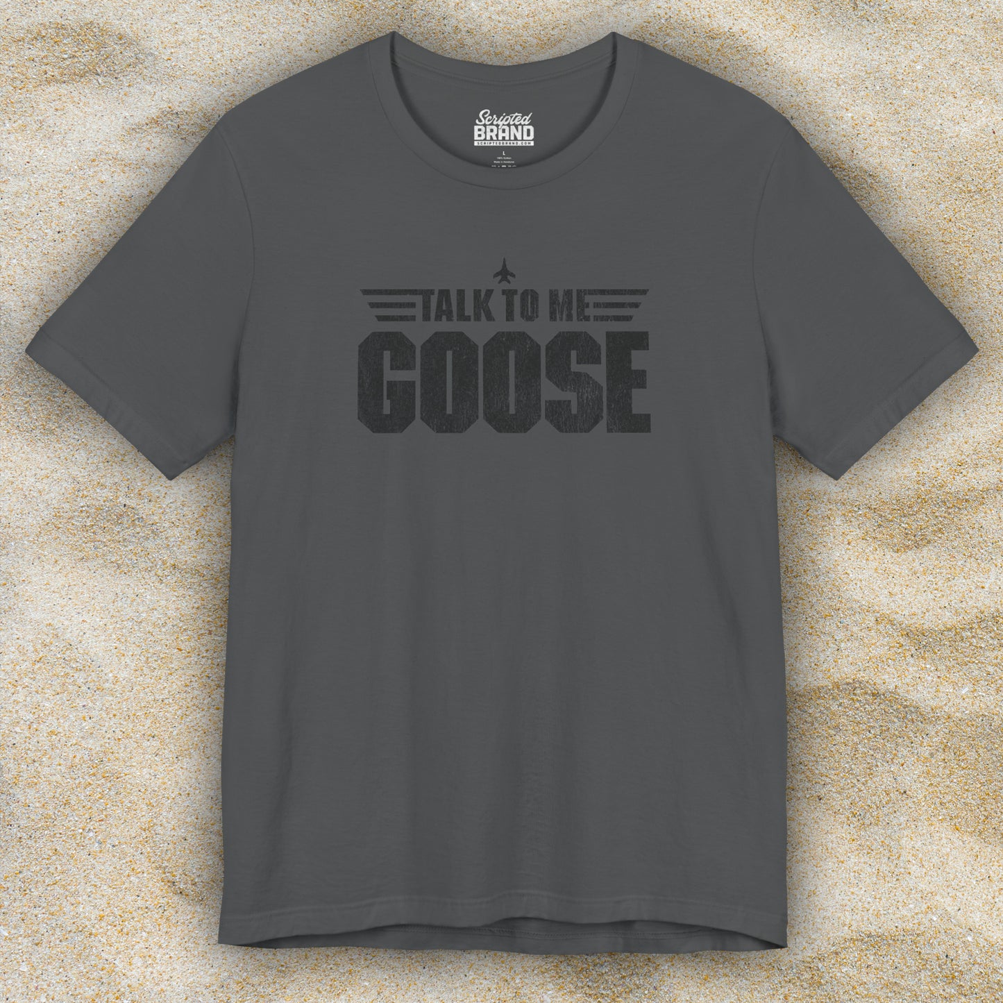 Front view of an asphalt grey soft unisex Bella+Canvas 3001 short-sleeve t-shirt featuring a graphic designed by ScriptedBrand in a vintage distressed style with the text TALK TO ME GOOSE, inspired by the Movie Top Gun.