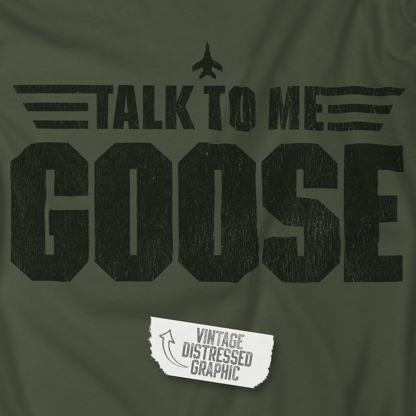 Closeup view of a military green soft unisex Bella+Canvas 3001 short-sleeve t-shirt featuring a graphic designed by ScriptedBrand in a vintage distressed style with the text TALK TO ME GOOSE, inspired by the Movie Top Gun.