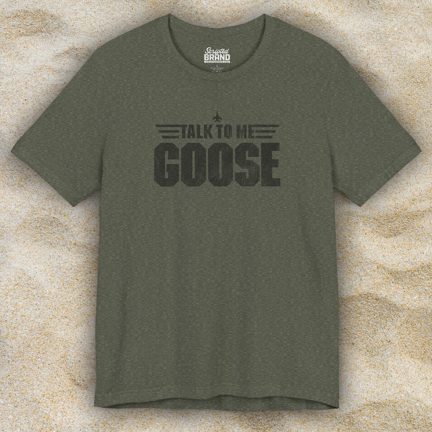 Front view of a heather military green soft unisex Bella+Canvas 3001 short-sleeve t-shirt featuring a graphic designed by ScriptedBrand in a vintage distressed style with the text TALK TO ME GOOSE, inspired by the Movie Top Gun.