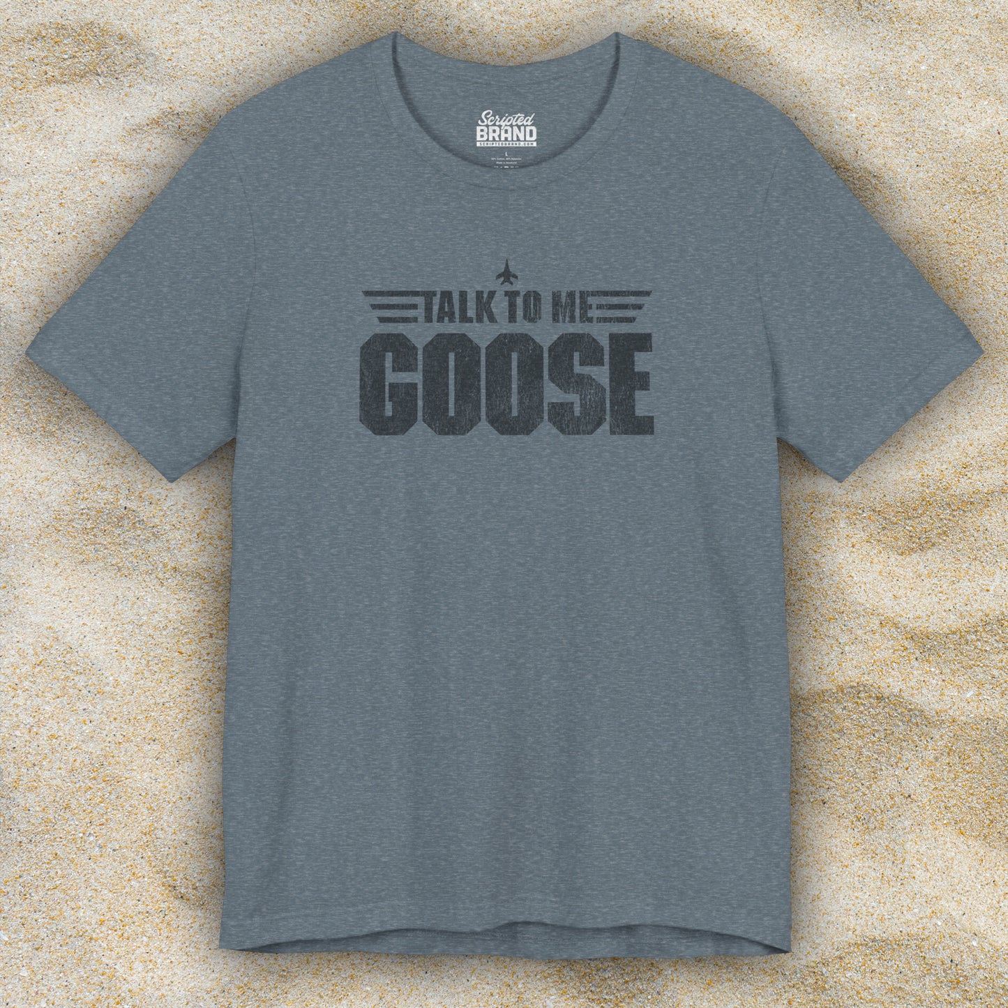 Front view of a heather slate soft unisex Bella+Canvas 3001 short-sleeve t-shirt featuring a graphic designed by ScriptedBrand in a vintage distressed style with the text TALK TO ME GOOSE, inspired by the Movie Top Gun.