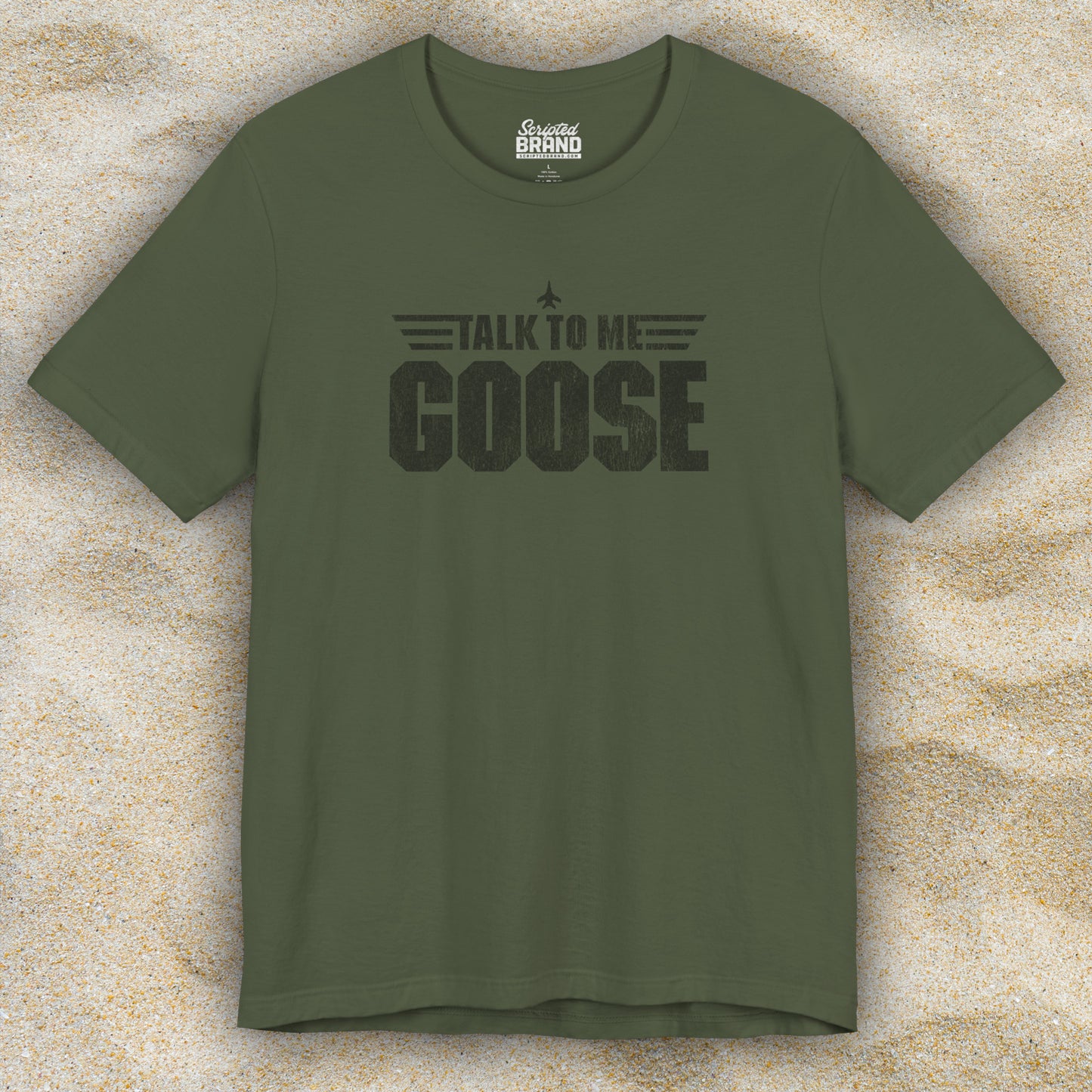 Front view of a military green soft unisex Bella+Canvas 3001 short-sleeve t-shirt featuring a graphic designed by ScriptedBrand in a vintage distressed style with the text TALK TO ME GOOSE, inspired by the Movie Top Gun.