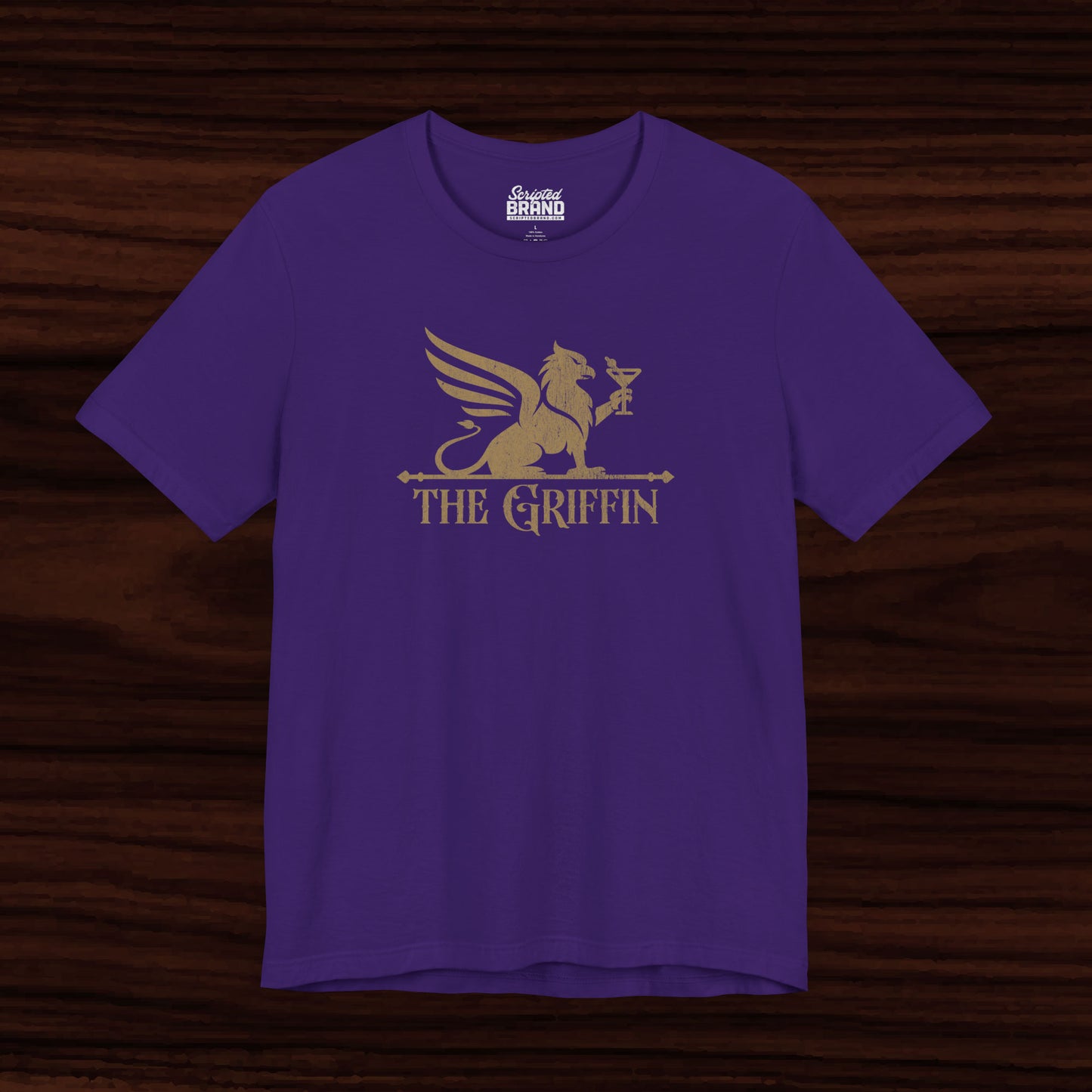Purple t-shirt featuring gold 'The Griffin' Bar logo inspired by the TV show New Girl in a vintage distressed style.