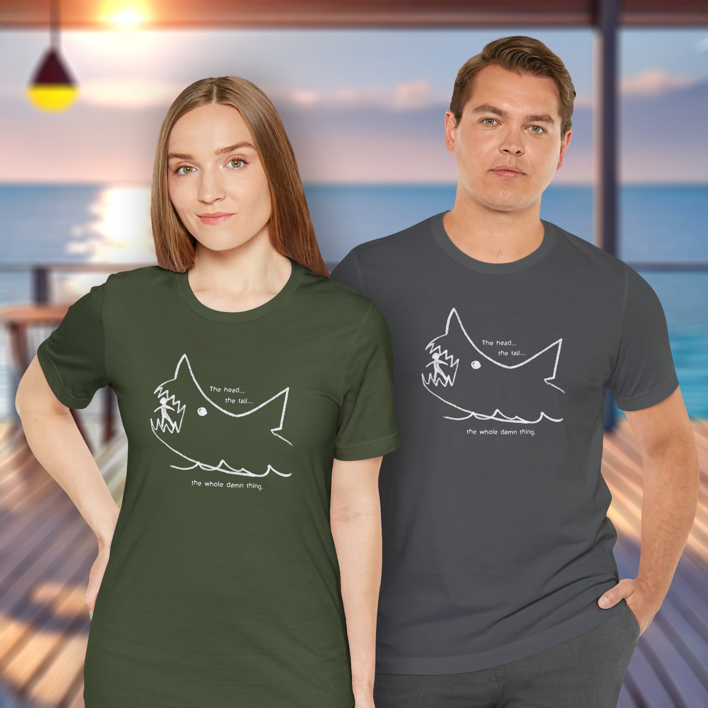 2 models wearing military green and asphalt gray colored soft short-sleeve Bella+Canvas 3001 t-shirts featuring the chalkboard drawing of a shark eating a person, drawn by Quint in the movie Jaws.