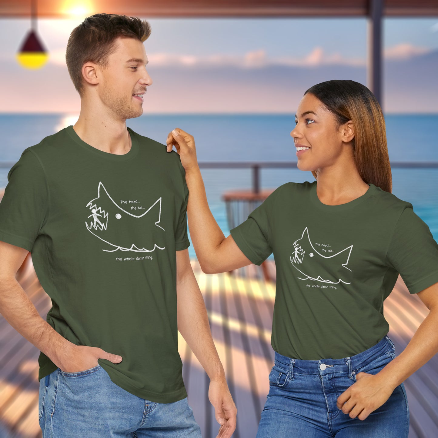 2 models wearing military green colored soft short-sleeve Bella+Canvas 3001 t-shirts featuring the chalkboard drawing of a shark eating a person, drawn by Quint in the movie Jaws.