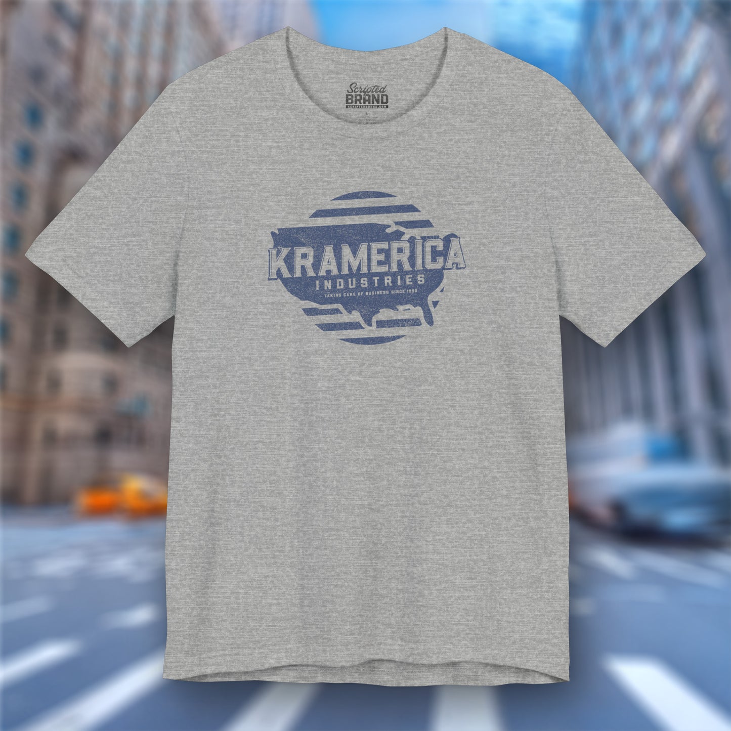 Front view of an athletic heather grey soft unisex Bella+Canvas 3001 short-sleeve t-shirt featuring a unique Kramerica Industries logo graphic, designed by ScriptedBrand in a vintage distressed style, and inspired by the TV show Seinfeld.
