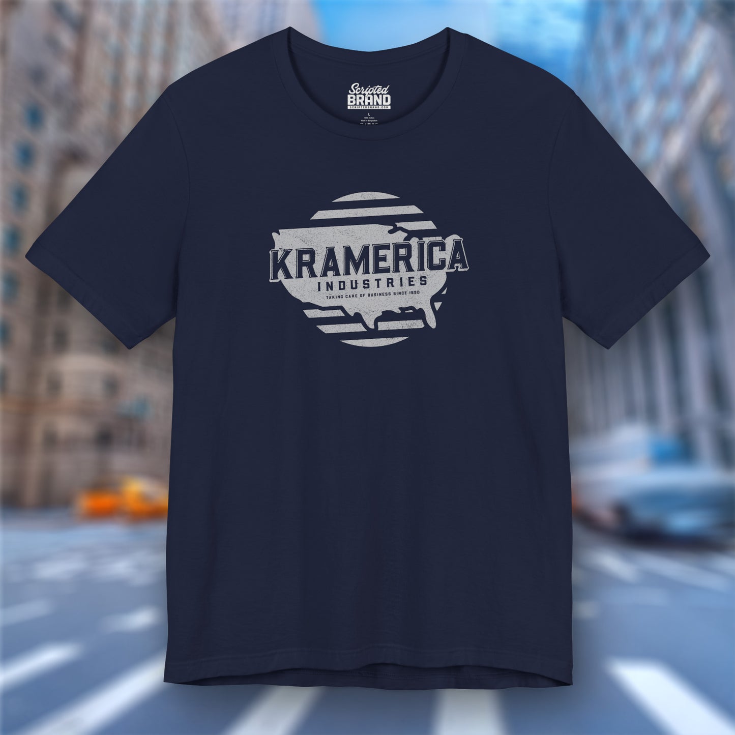 Front view of a navy blue soft unisex Bella+Canvas 3001 short-sleeve t-shirt featuring a unique Kramerica Industries logo graphic, designed by ScriptedBrand in a vintage distressed style, and inspired by the TV show Seinfeld.