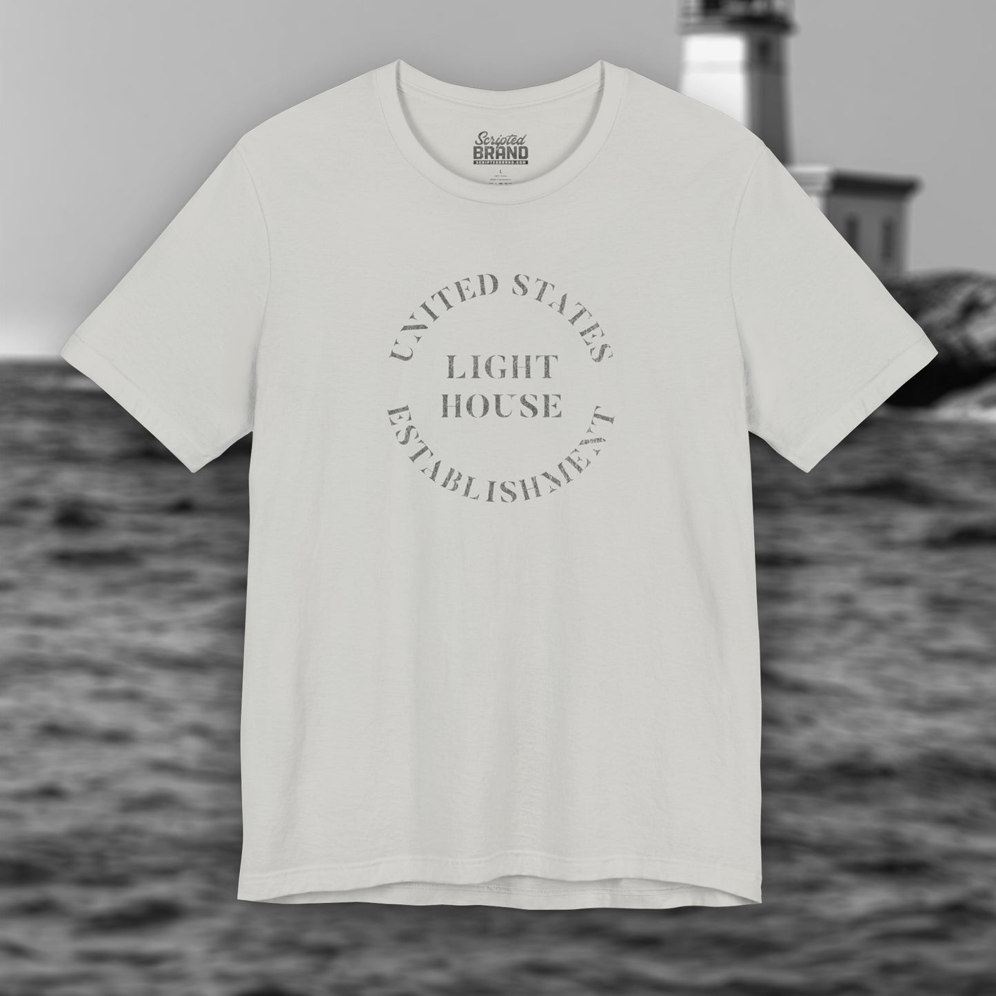 Silver t-shirt featuring the United States Light House Establishment logo graphic worn by Robert Pattinson in the movie The Lighthouse in a vintage distressed style.