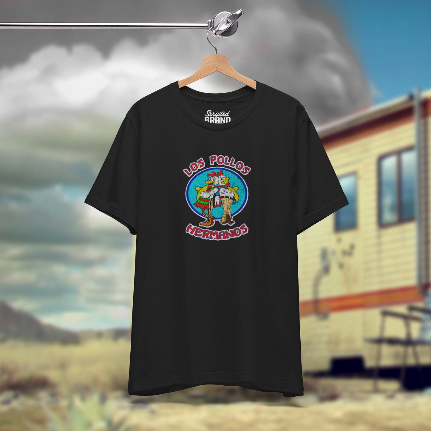 Front view of a hanging black Soft short-sleeve Bella+Canvas 3001 t-shirt featuring the Los Pollos Hermanos logo graphic from the TV show Breaking Bad in a vintage distressed style.