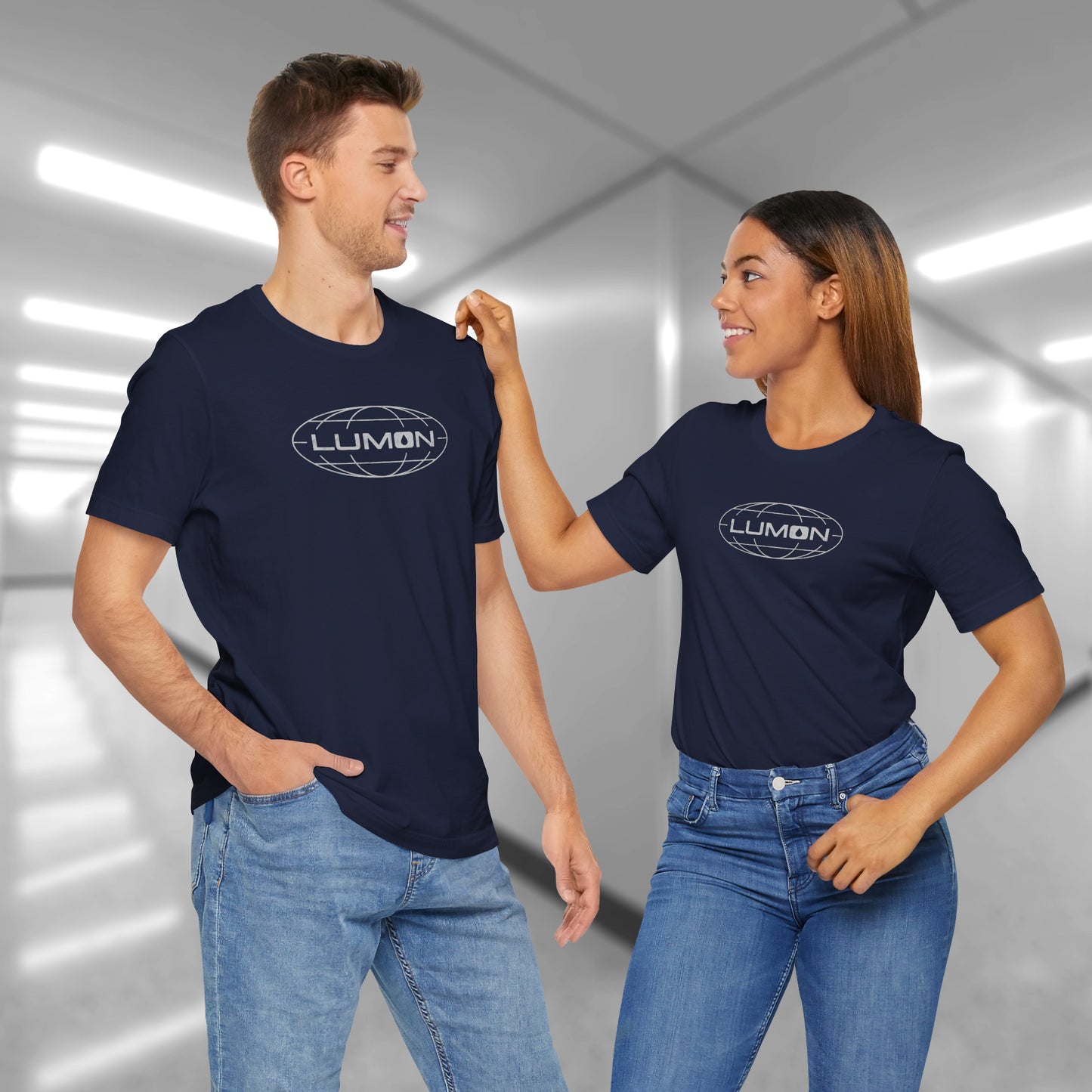 2 models wearing navy colored soft Bella+Canvas shirtsleeve t-shirts with the Lumon Industries logo from the TV show Severance in a vintage distressed ink-stamped style.