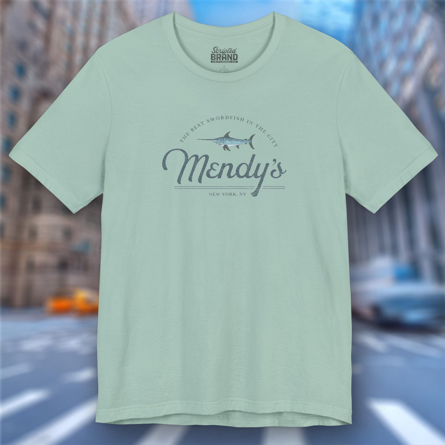 Front view of a dusty blue colored soft unisex Bella+Canvas 3001 short-sleeve t-shirt featuring a unique Mendy's Restaurant logo graphic, designed by ScriptedBrand in a vintage distressed style, and inspired by the TV show Seinfeld.
