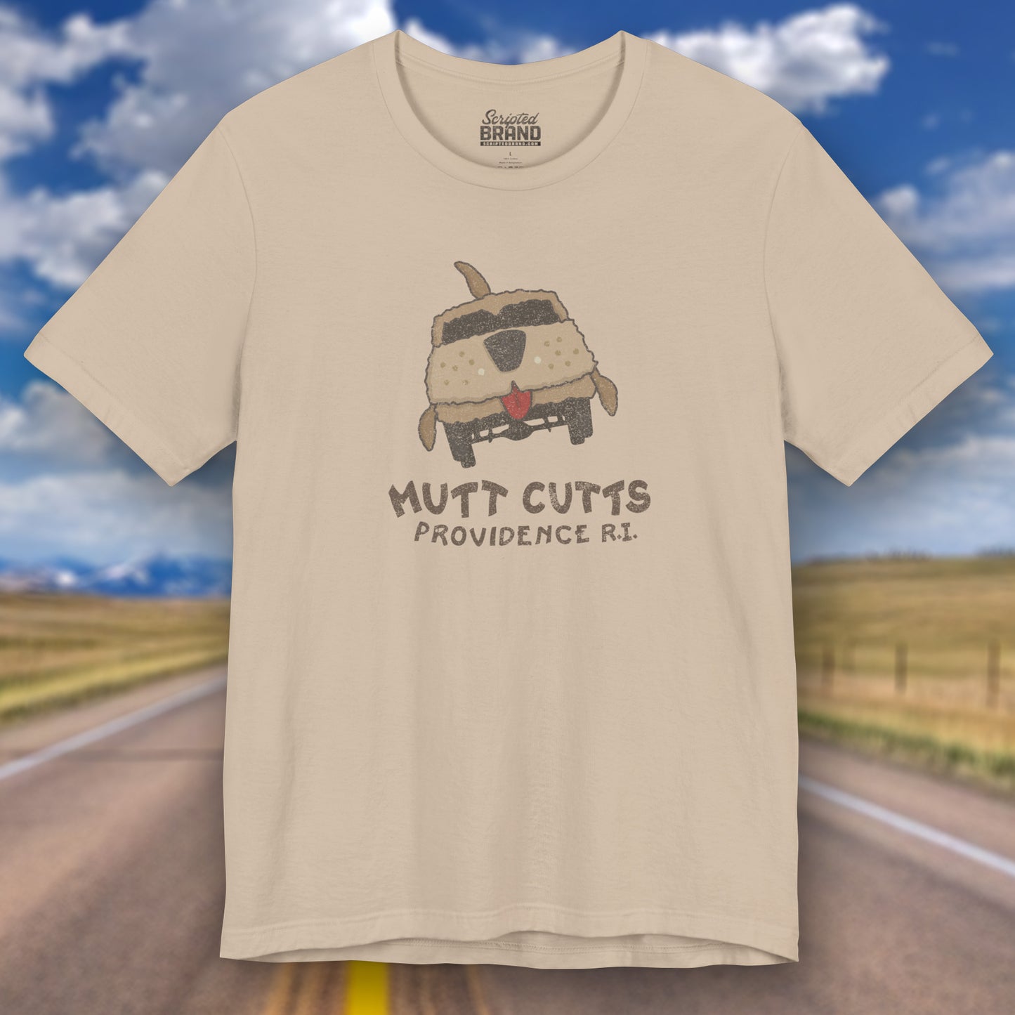 Front view of a tan colored Soft unisex Bella+Canvas 3001 short-sleeve t-shirt featuring a Mutt Cutts logo graphic inspired by the movie Dumb and Dumber, illustrated by ScriptedBrand in a vintage distressed style.