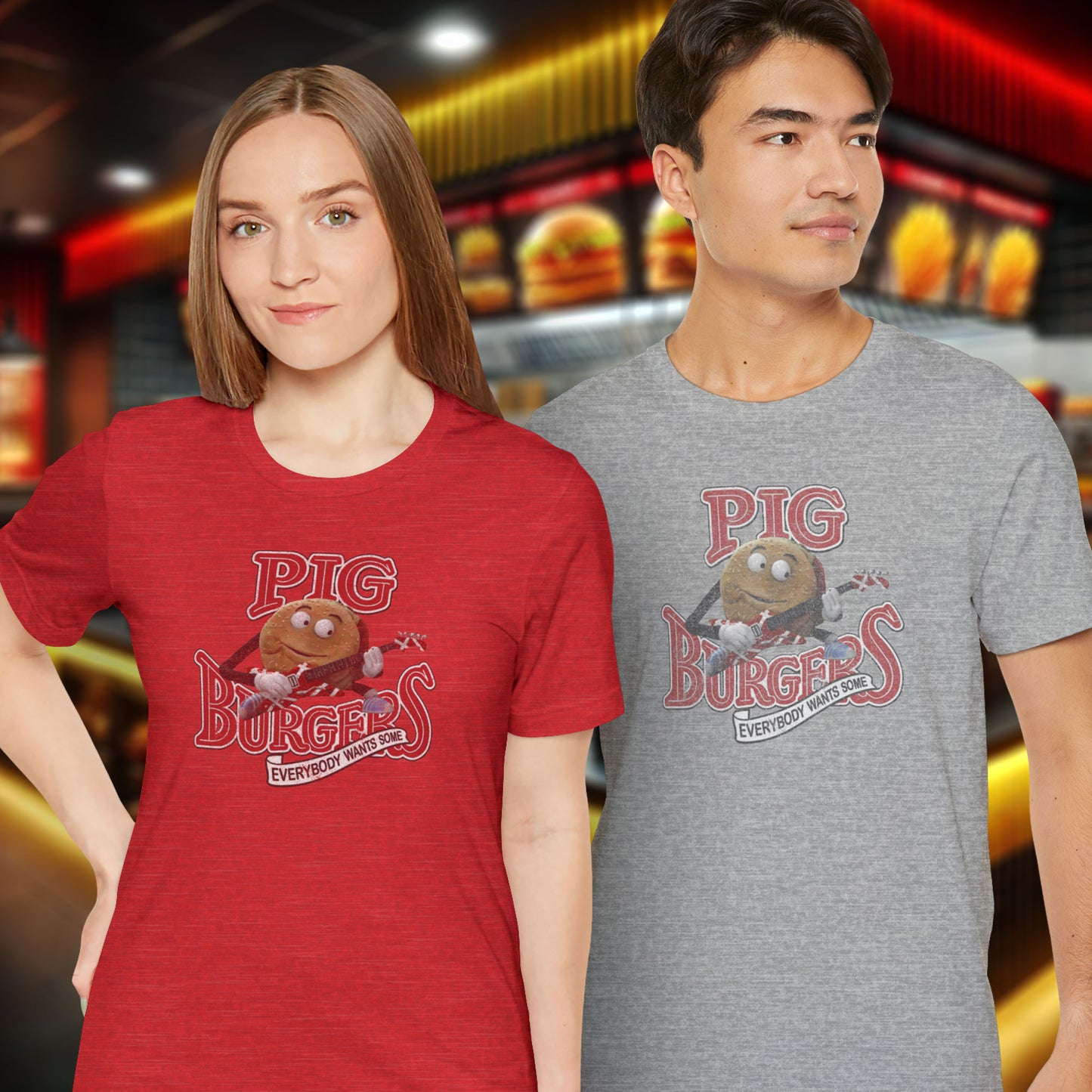 2 models wearing red and gray soft Bella+Canvas 3001 short-sleeve t-shirts featuring a graphic of the fictional Pig Burgers logo from the movie Better Off Dead, along with the Van Halen singing hamburger playing guitar, with the small subhead phrase EVERYBODY WANTS SOME. The graphic is designed in a vintage distressed style, sold by ScriptedBrand.