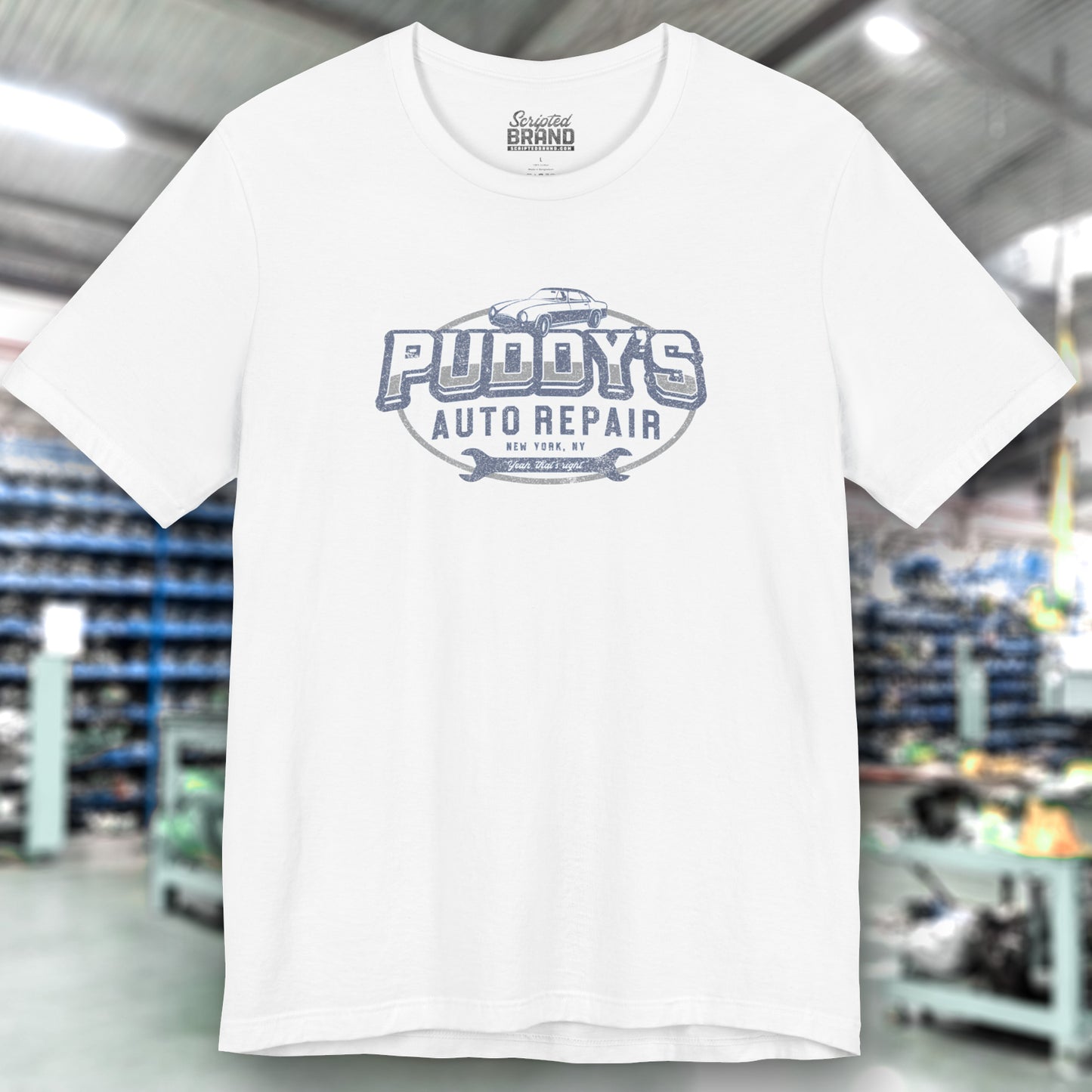 Front view of a white soft short-sleeve t-shirt featuring a Puddy's Auto Repair graphic designed by ScriptedBrand inspired by the TV show Seinfeld in a vintage distressed ink-stamped worn-in style.