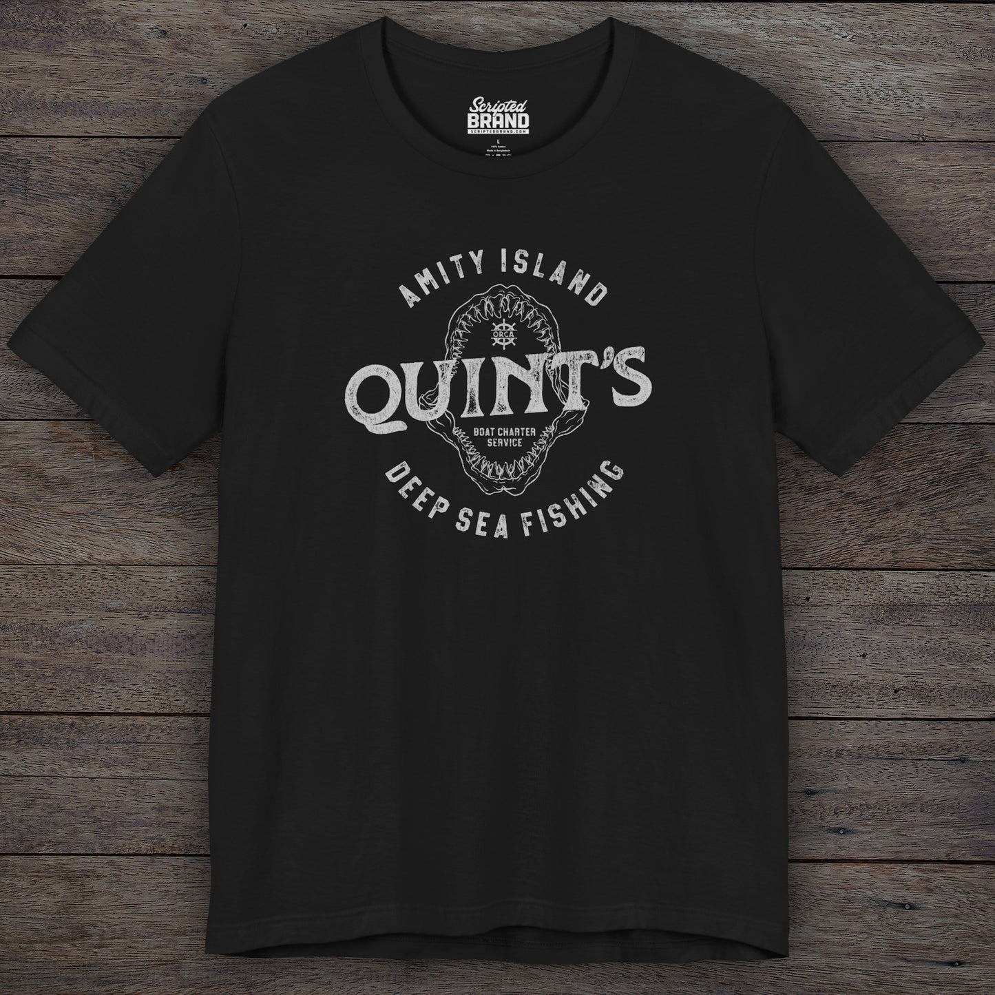 Black colored Soft short-sleeve t-shirt featuring the Quint's Deep Sea Fishing Boat Charters logo graphic inspired by the movie Jaws in a vintage distressed ink-stamped worn-in style.