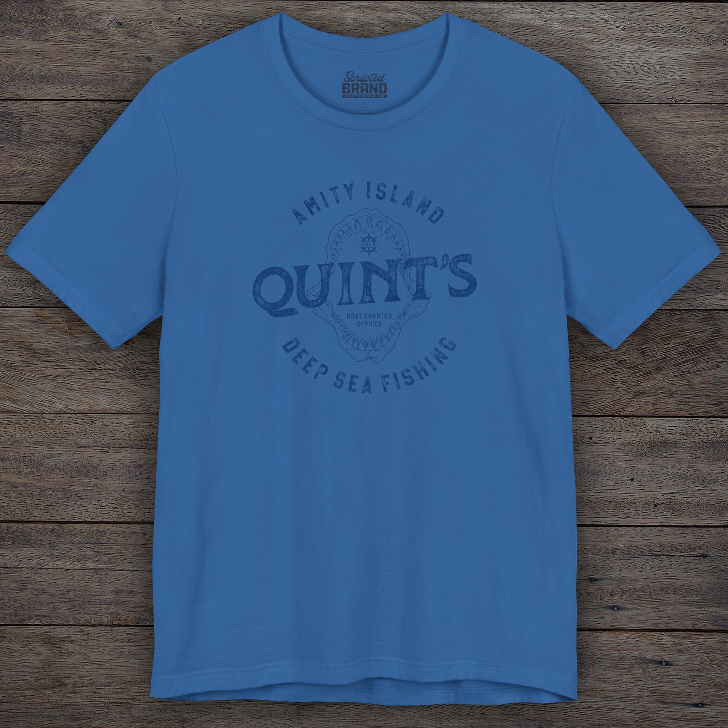 Columbia blue colored Soft short-sleeve t-shirt featuring the Quint's Deep Sea Fishing Boat Charters logo graphic inspired by the movie Jaws in a vintage distressed ink-stamped worn-in style.
