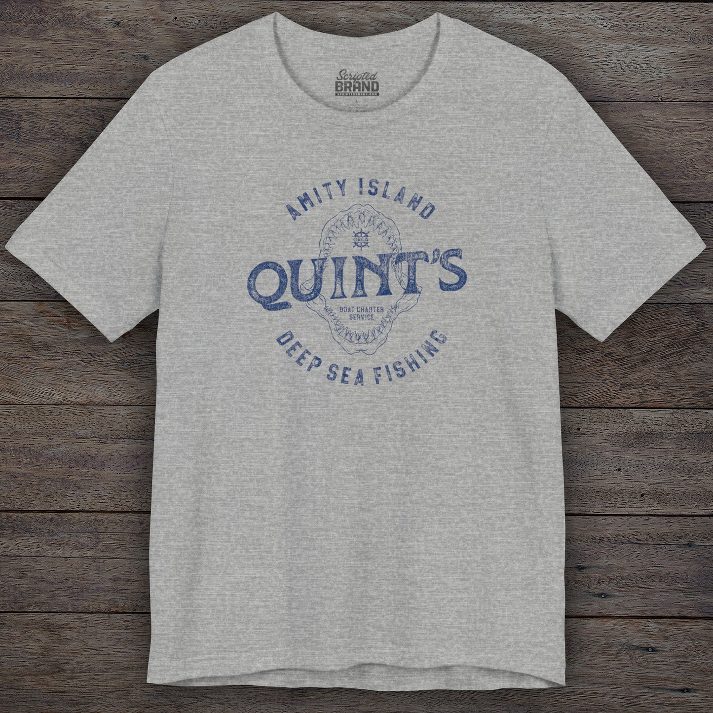 Athletic Heather Gray Soft short-sleeve t-shirt featuring the Quint's Deep Sea Fishing Boat Charters logo graphic inspired by the movie Jaws in a vintage distressed ink-stamped worn-in style.
