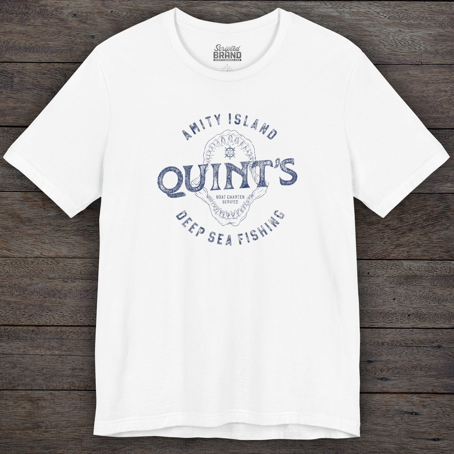 White colored Soft short-sleeve t-shirt featuring the Quint's Deep Sea Fishing Boat Charters logo graphic inspired by the movie Jaws in a vintage distressed ink-stamped worn-in style.