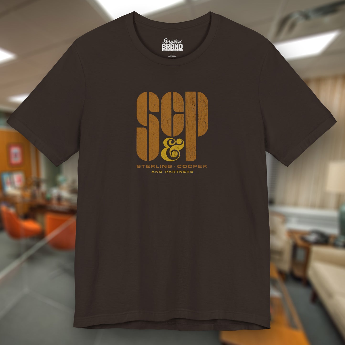 Front view of a brown colored soft unisex Bella+Canvas 3001 short-sleeve t-shirt featuring the Sterling Cooper & Partners logo graphic from the TV Show Mad Men in a vintage distressed style, sold by ScriptedBrand.