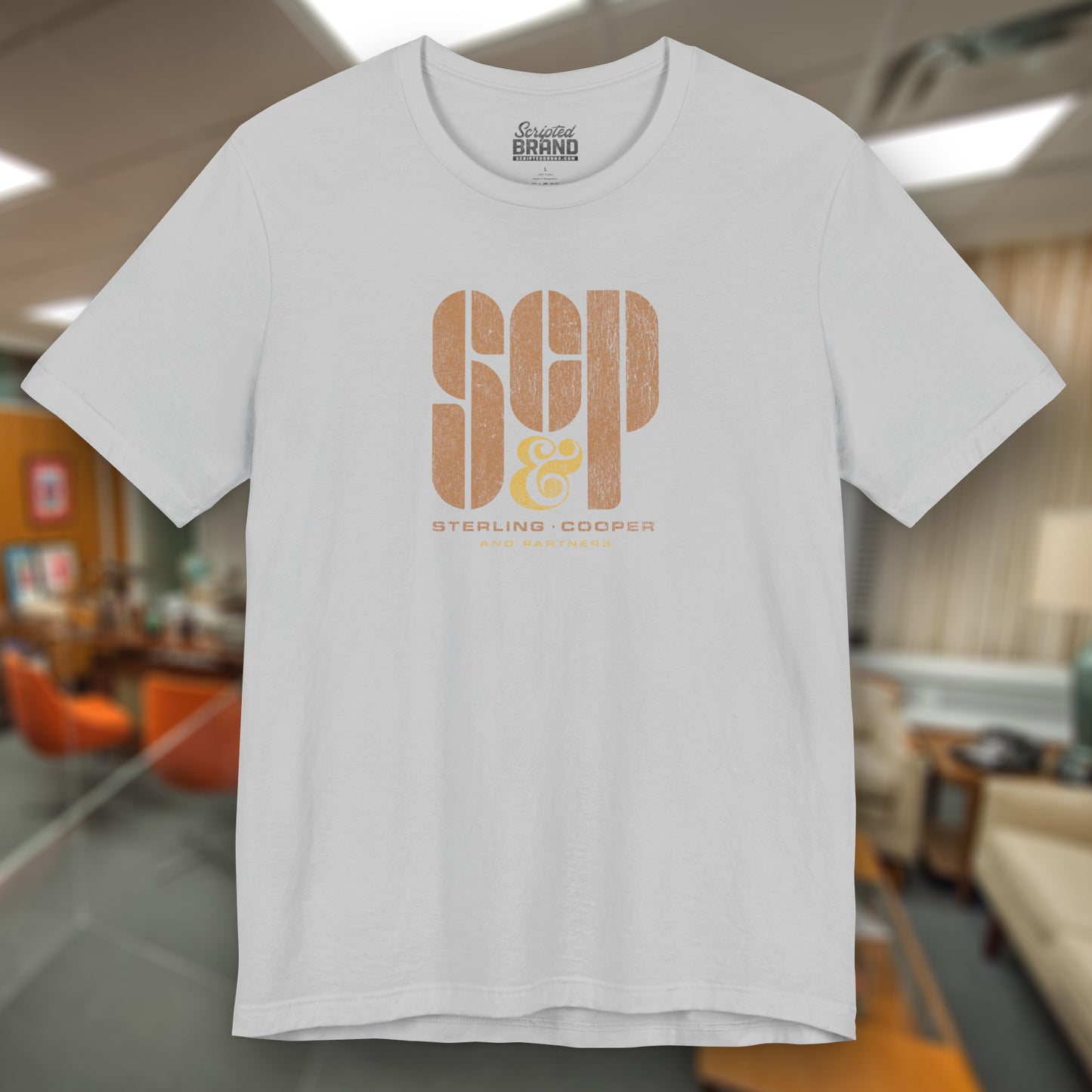 Front view of a solid athletic grey colored soft unisex Bella+Canvas 3001 short-sleeve t-shirt featuring the Sterling Cooper & Partners logo graphic from the TV Show Mad Men in a vintage distressed style, sold by ScriptedBrand.