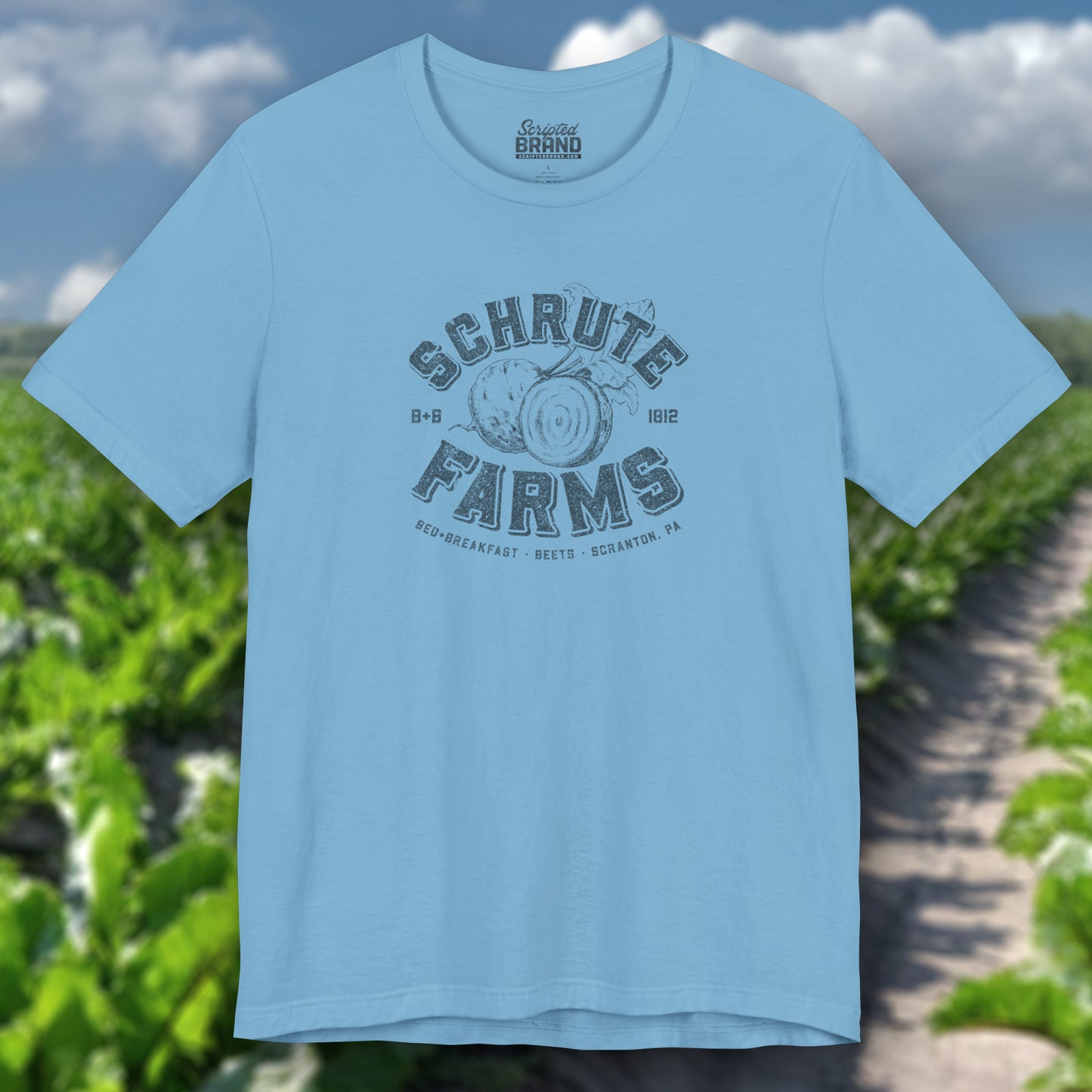 Ocean blue t-shirt featuring a Schrute Farms logo from the TV show The Office designed by ScriptedBrand in a vintage distressed style.