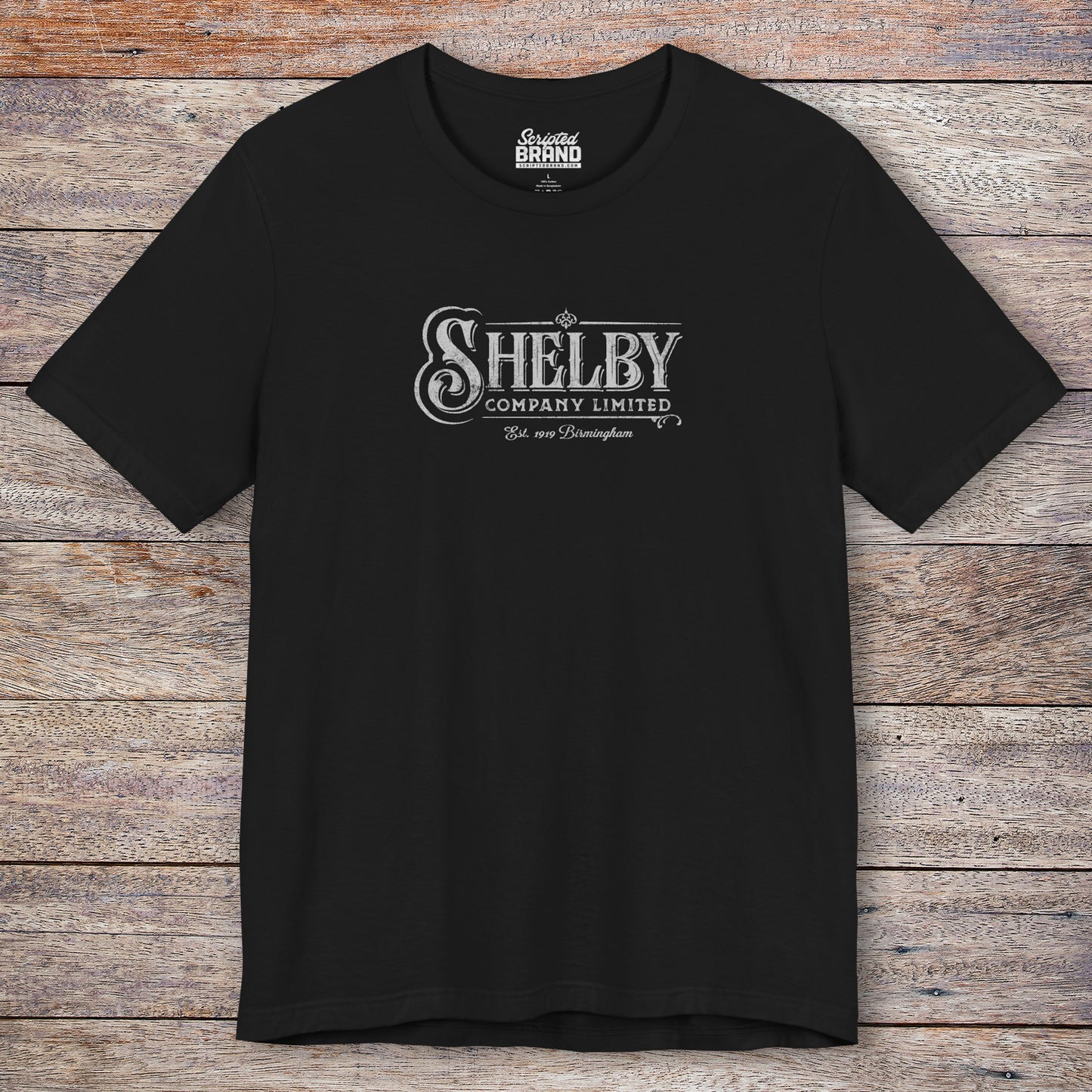 Front view of a black soft short-sleeve Bella+Canvas 3001 t-shirt featuring the Shelby Company Limited logo from the show Peaky Blinders in a vintage distressed style, sold by ScriptedBrand.