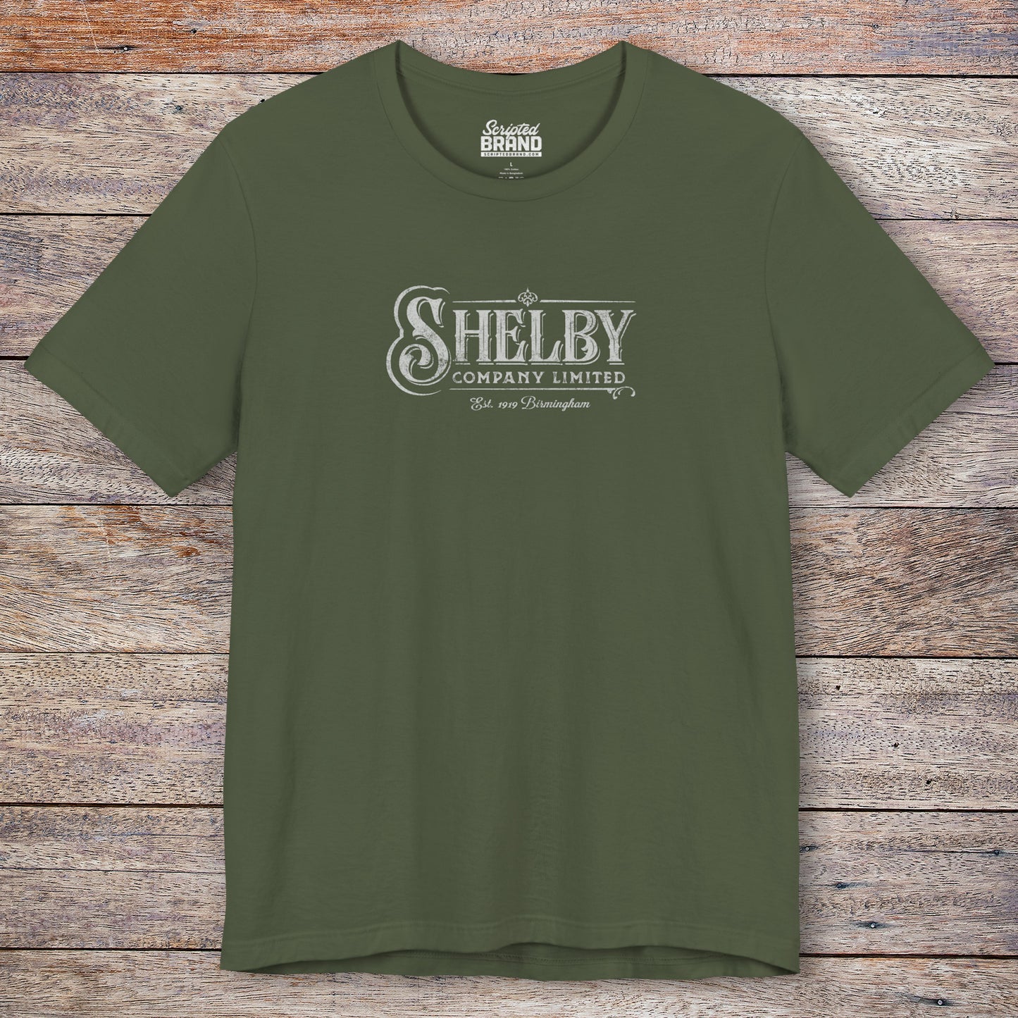 Front view of a military green soft short-sleeve Bella+Canvas 3001 t-shirt featuring the Shelby Company Limited logo from the show Peaky Blinders in a vintage distressed style, sold by ScriptedBrand.