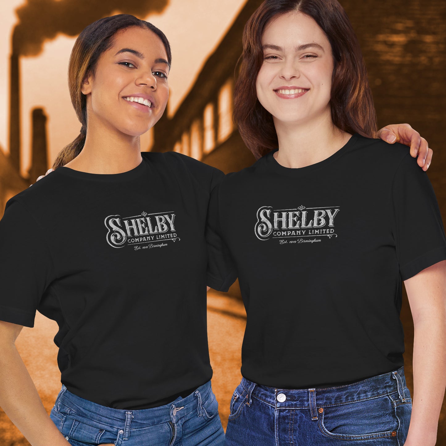 2 female models wearing black soft short-sleeve Bella+Canvas 3001 t-shirts featuring the Shelby Company Limited logo from the show Peaky Blinders in a vintage distressed style, sold by ScriptedBrand.