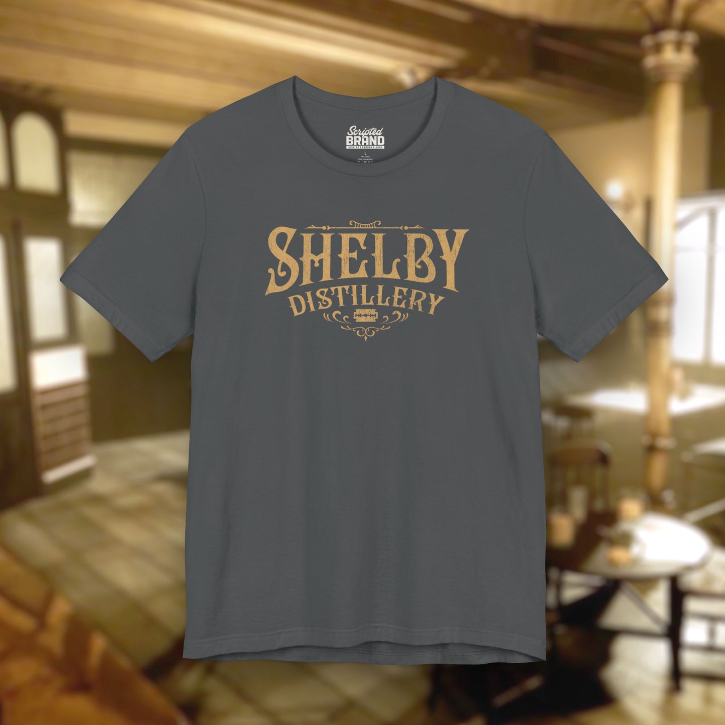 Front view of a asphalt gray Soft Bella+Canvas 3001 short-sleeve t-shirt featuring the Shelby Company Limited Distillery Logo Graphic inspired by the TV show and movie Peaky Blinders in a vintage distressed style, sold by ScriptedBrand.