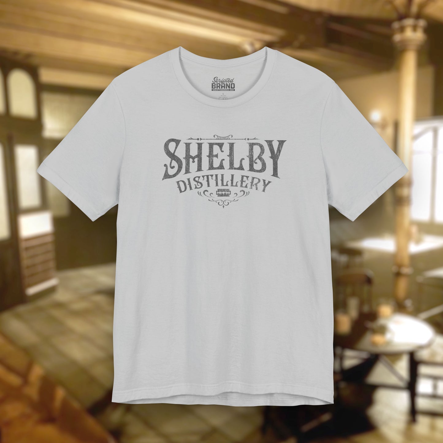 Front view of a solid athletic gray Soft Bella+Canvas 3001 short-sleeve t-shirt featuring the Shelby Company Limited Distillery Logo Graphic inspired by the TV show and movie Peaky Blinders in a vintage distressed style, sold by ScriptedBrand.