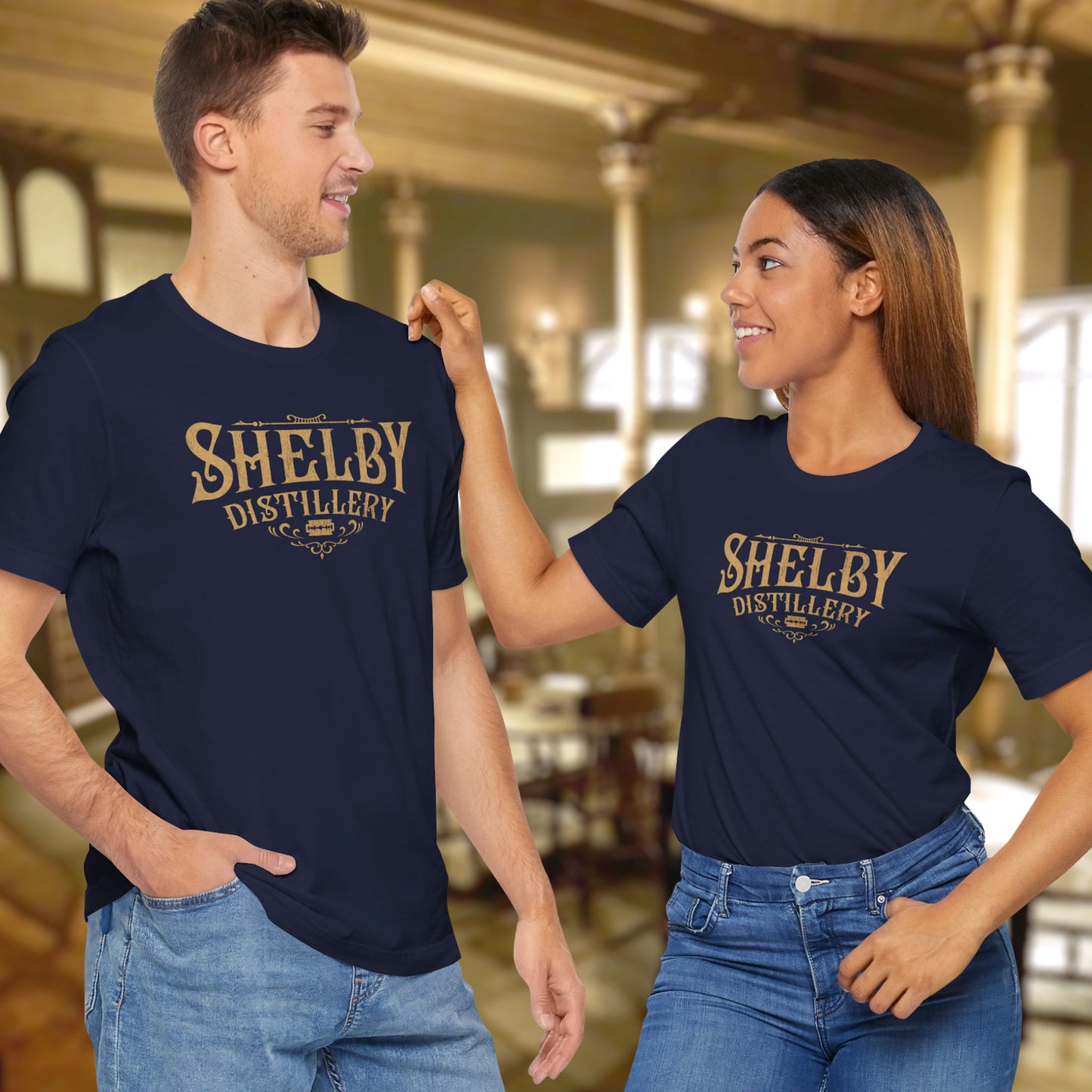 2 models wearing navy blue Soft Bella+Canvas 3001 short-sleeve t-shirts featuring the Shelby Company Limited Distillery Logo Graphic inspired by the TV show and movie Peaky Blinders in a vintage distressed style, sold by ScriptedBrand.