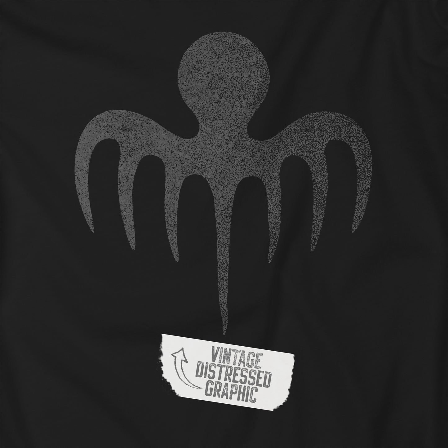 Closeup view of a black colored soft Bella+Canvas 3001 short-sleeve t-shirt featuring a logo graphic of the fictional criminal organization Spectre, inspired by the James Bond movie franchise, in a vintage distressed style.