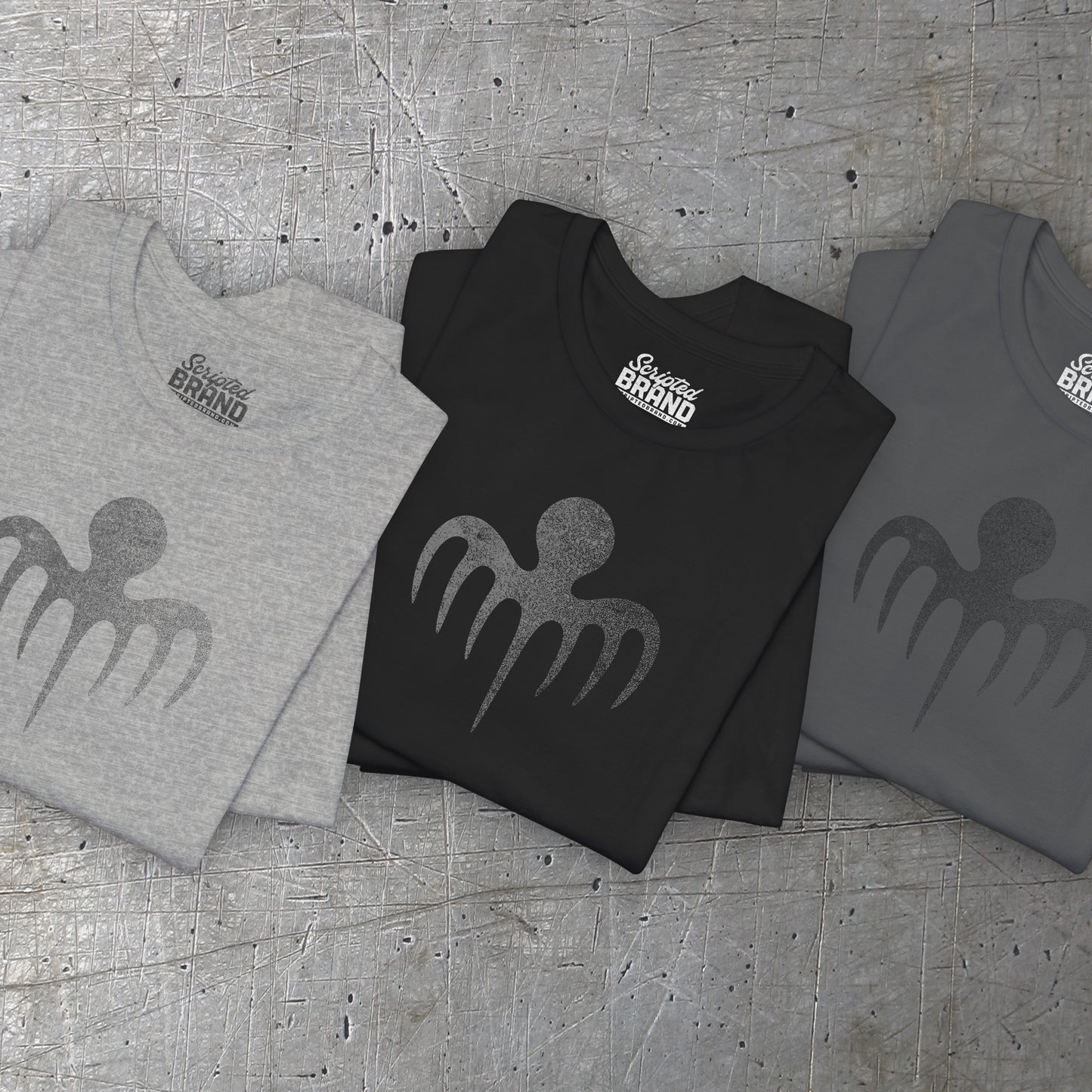 Groupp of 3 folded soft Bella+Canvas 3001 short-sleeve t-shirts featuring a logo graphic of the fictional criminal organization Spectre, inspired by the James Bond movie franchise, in a vintage distressed style.