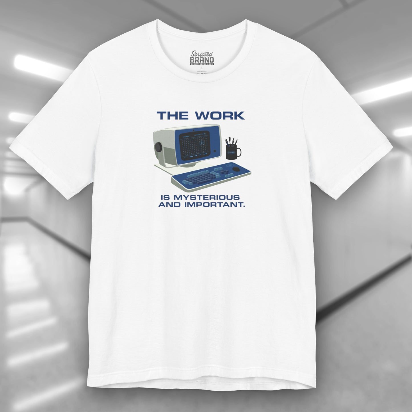 Front view of a white Soft Bella+Canvas shirtsleeve t-shirt featuring the retro computer workstation from the Apple TV show Severance, and includes the text The Work is Mysterious and Important. Graphic is designed and illustrated by ScriptedBrand.