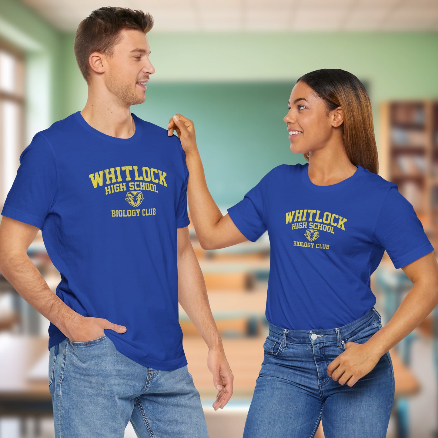 Two people wearing blue t-shirts featuring gold Whitlock High School Rams logo graphic inspired by the TV show AP Bio in a vintage style.